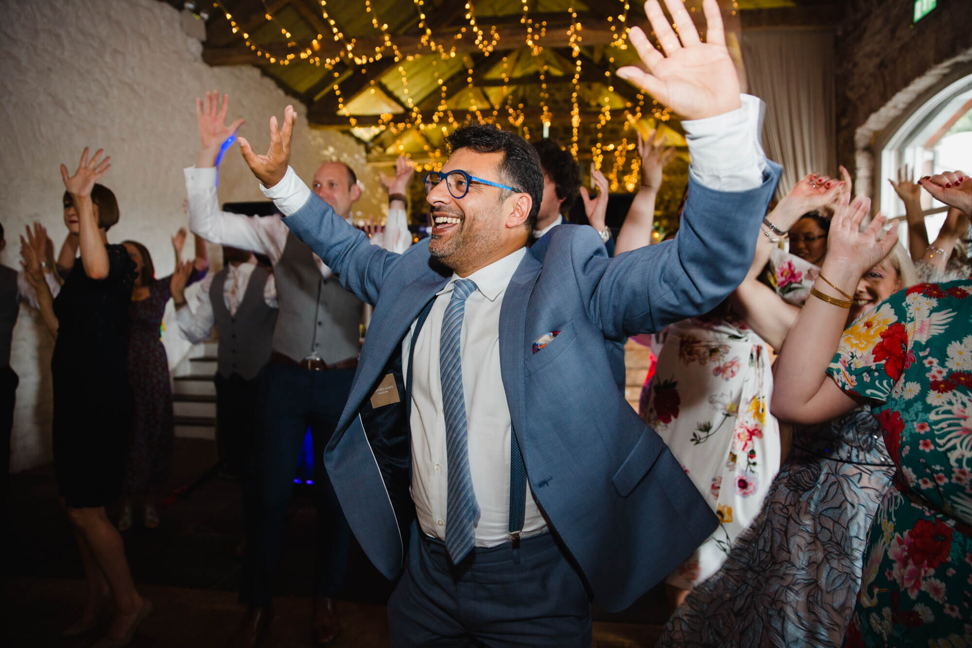 family dancing to bhangra music at the end of wedding day
