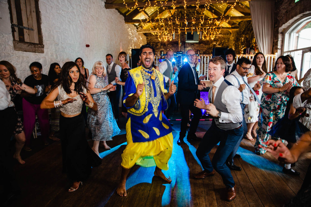 wide angle of dancing in Askham Hall barn