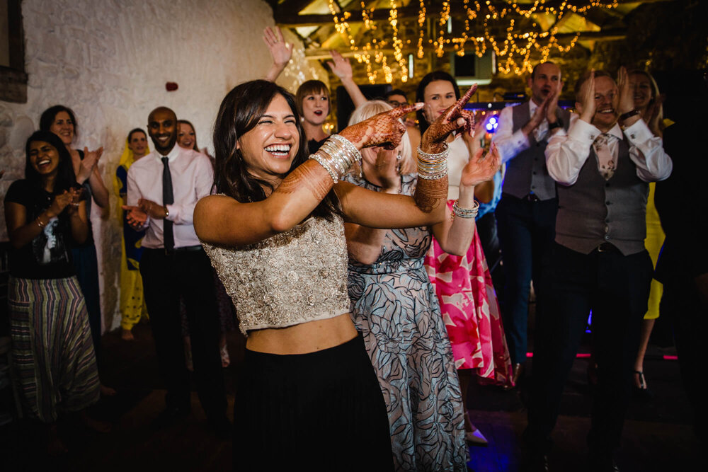 bride laughing and pointing directions to groom