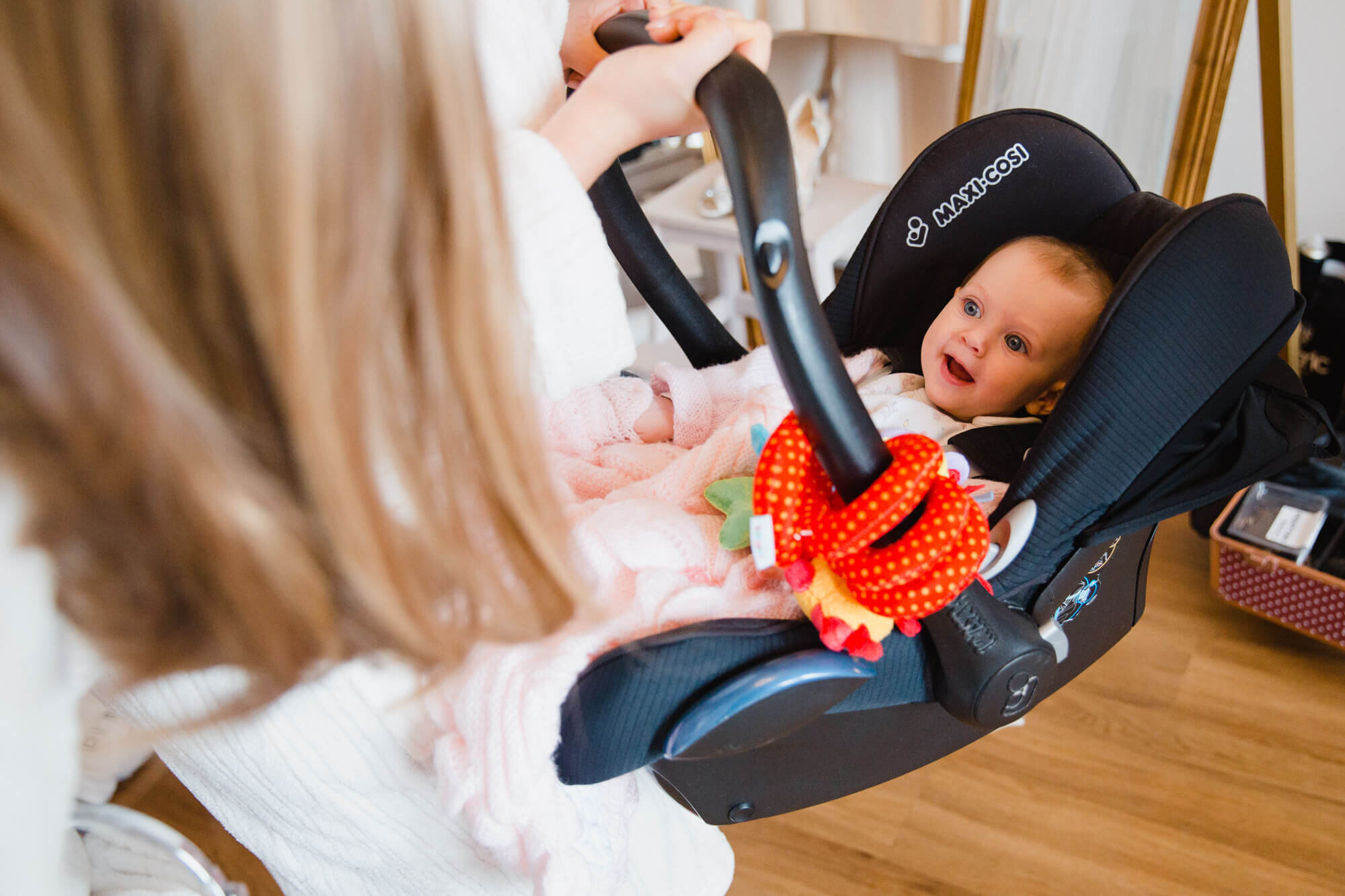 close up photograph of baby smiling at bridesmaids