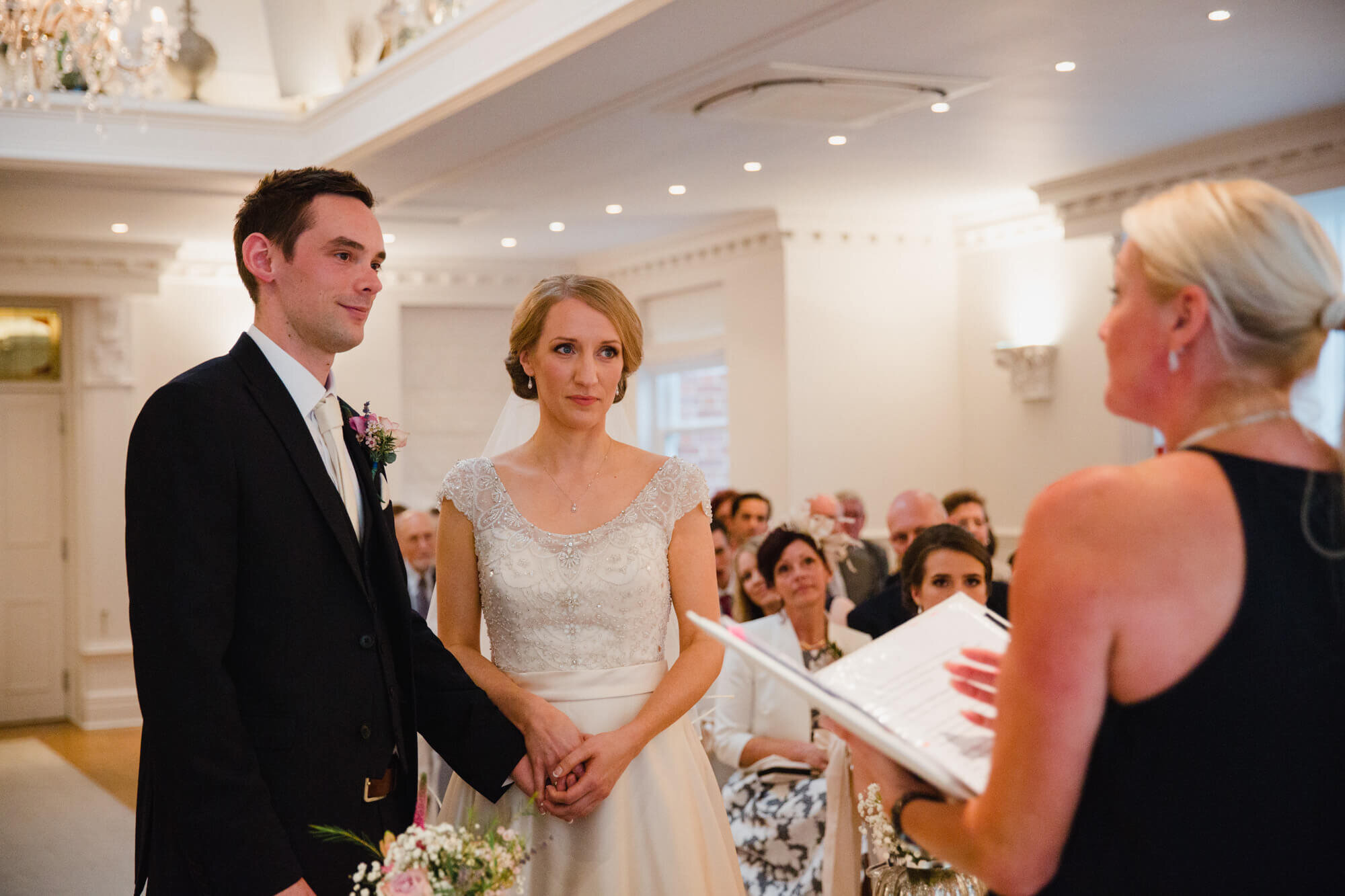 newlyweds holding hands during service at Ashfield House