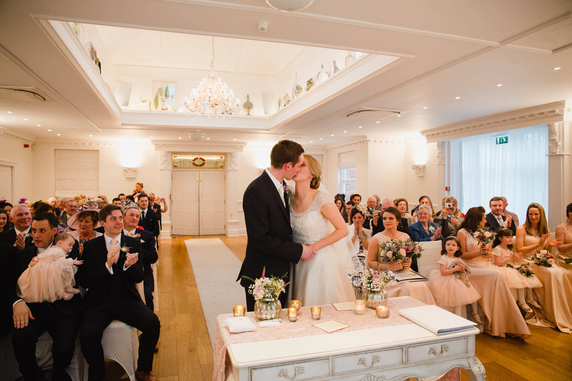 wide angle lens photograph of newly married couple first kiss at award winning Ashfield House