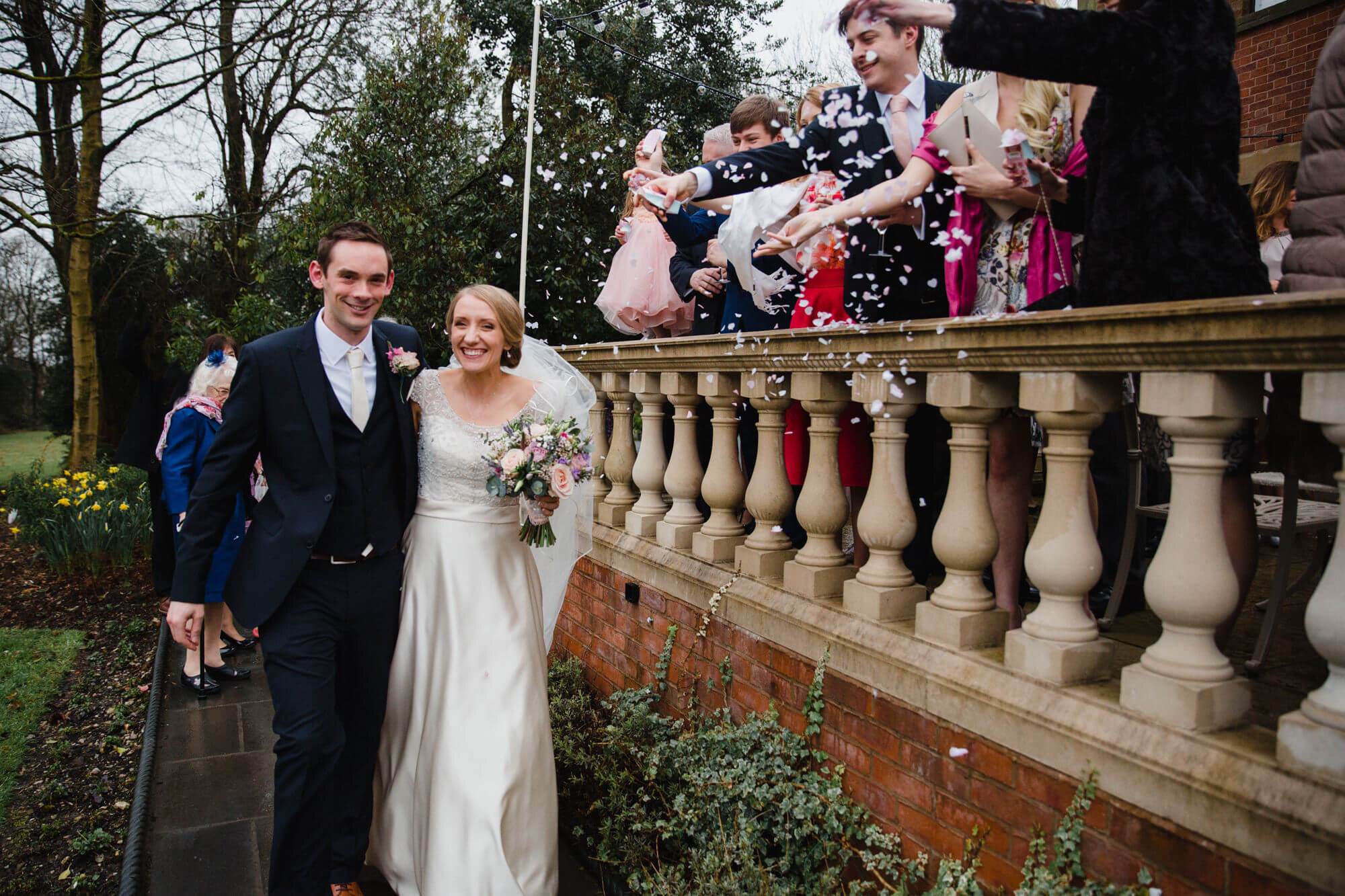 newly married couple enjoy confetti being thrown