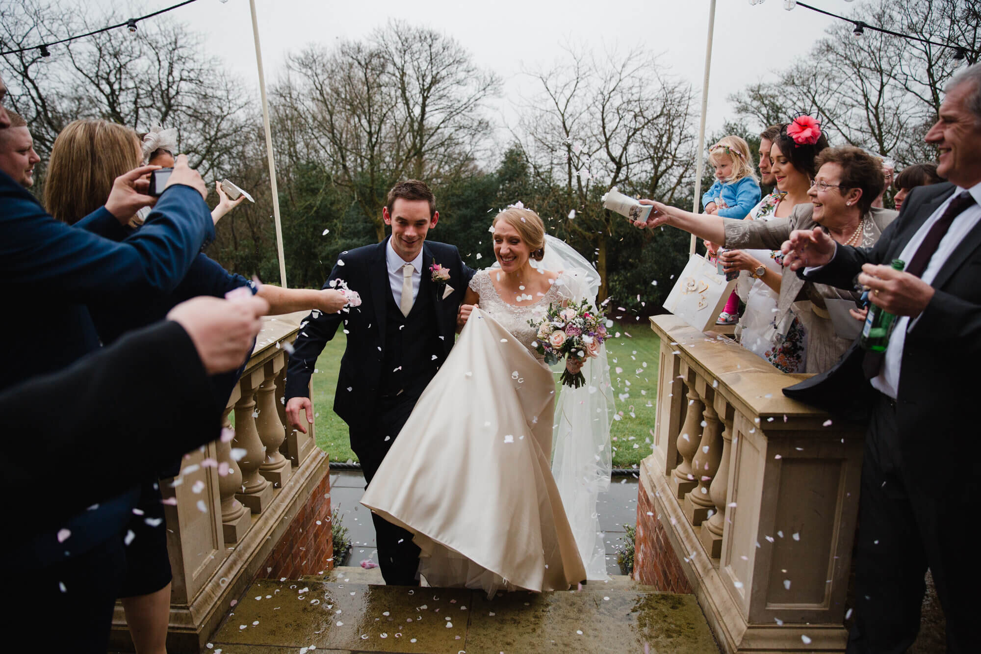 Newly married couple enjoy confetti throwing on steps of Ashfield House