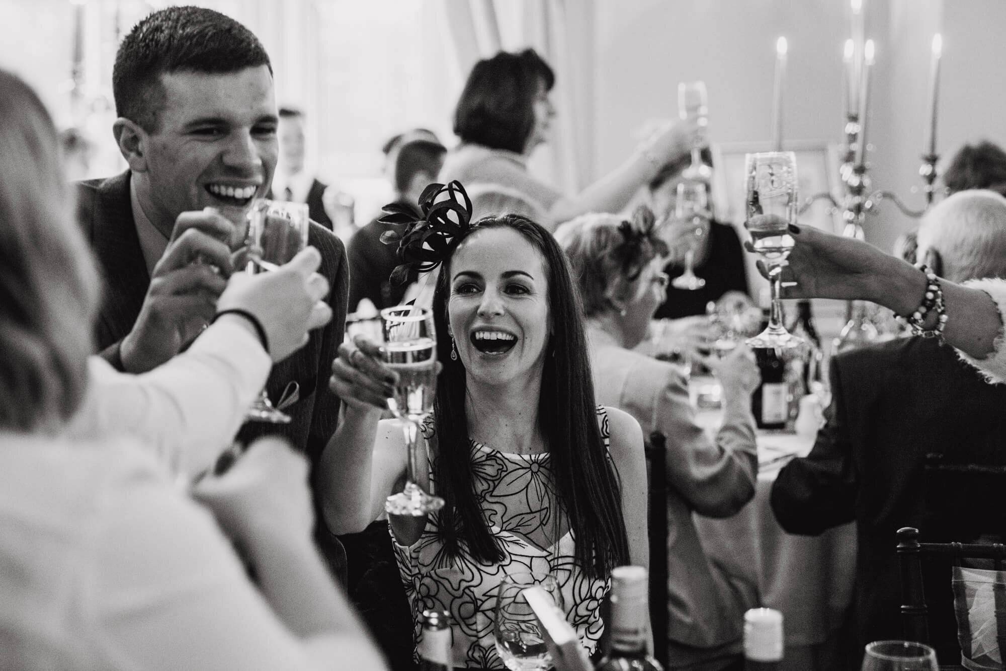 wedding guests raise drinks to congratulate couple