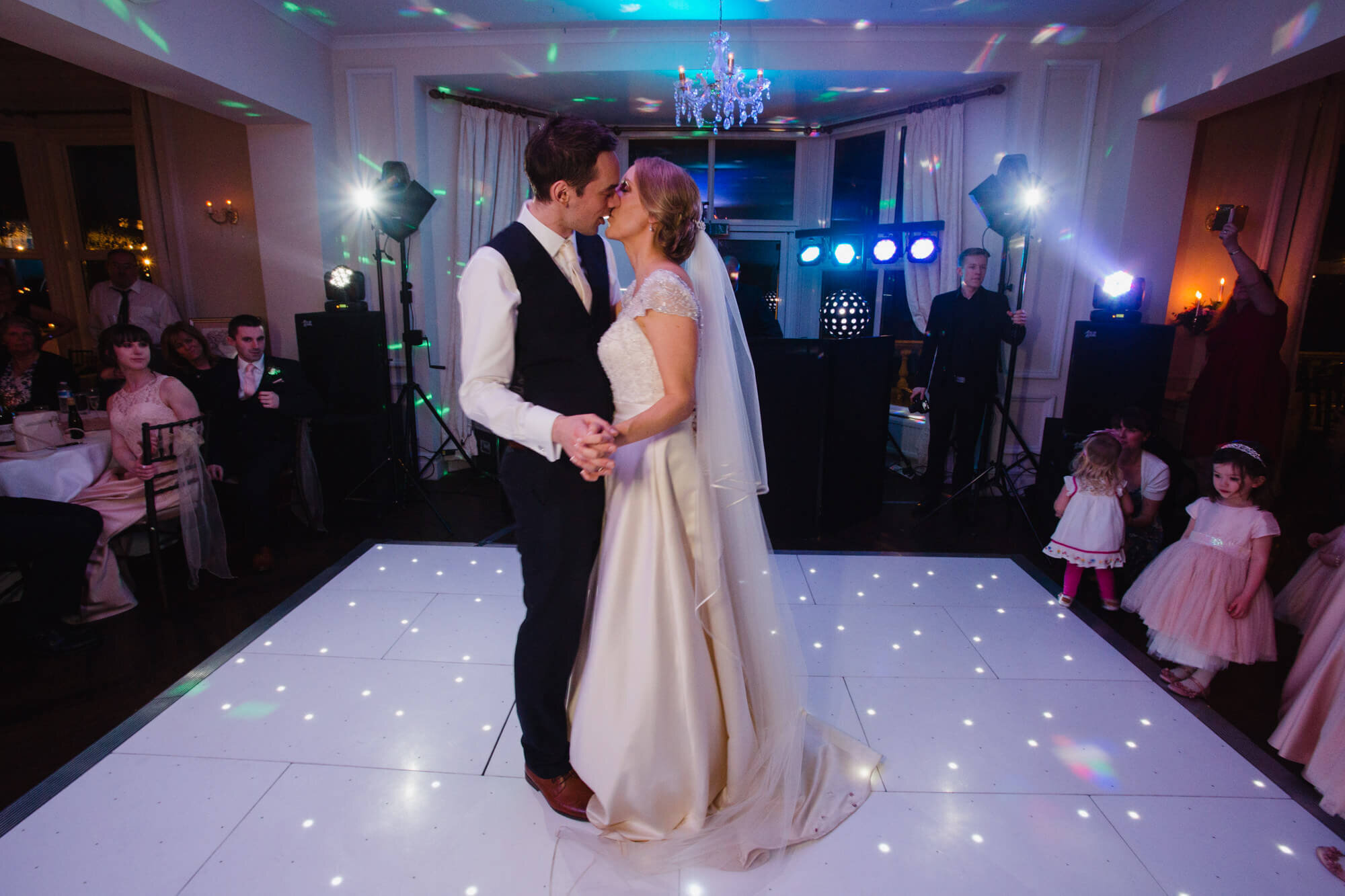 bride and groom exchange kiss on dance floor