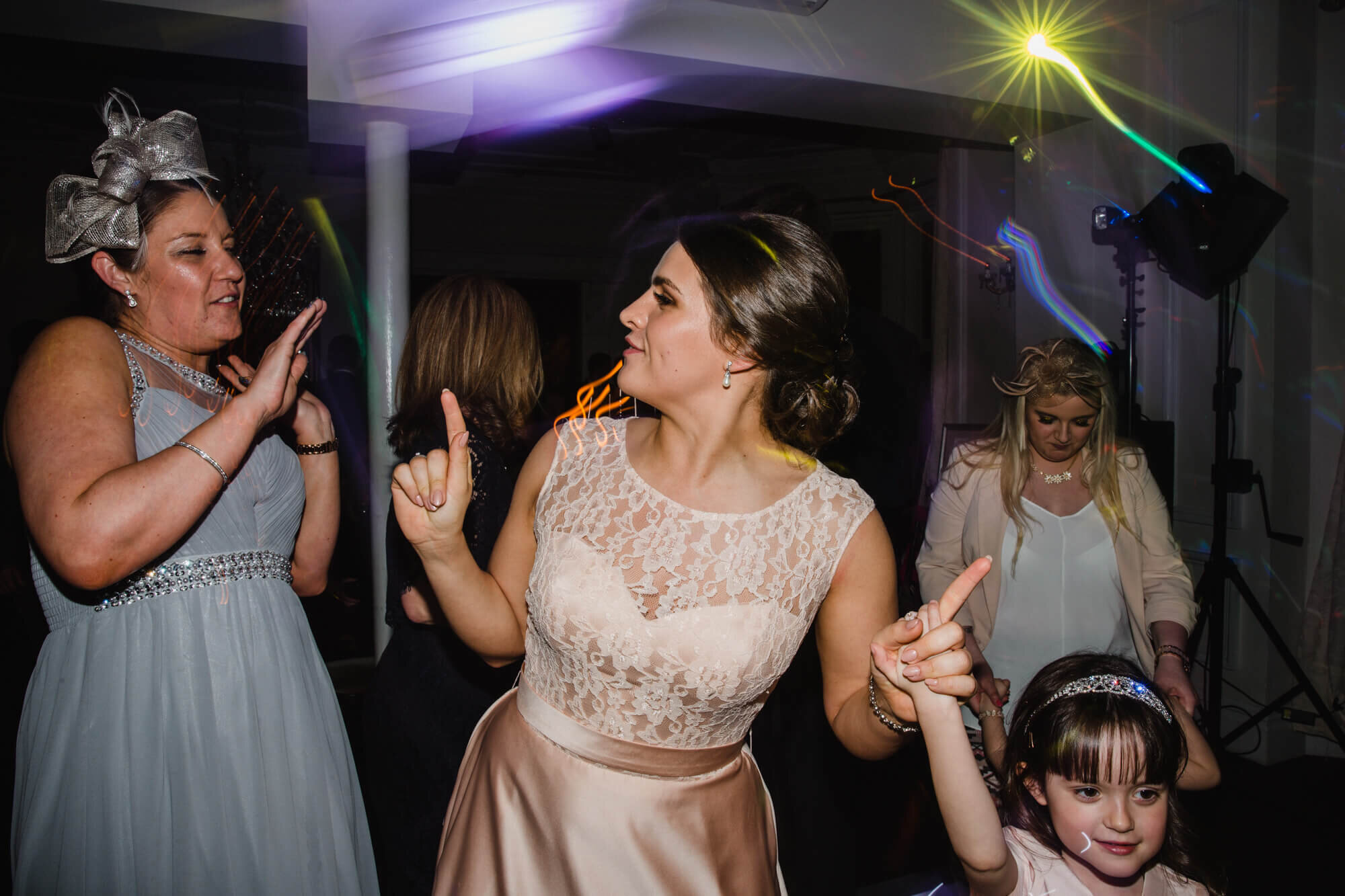 creative shutter drag photograph of bridesmaid on dancefloor