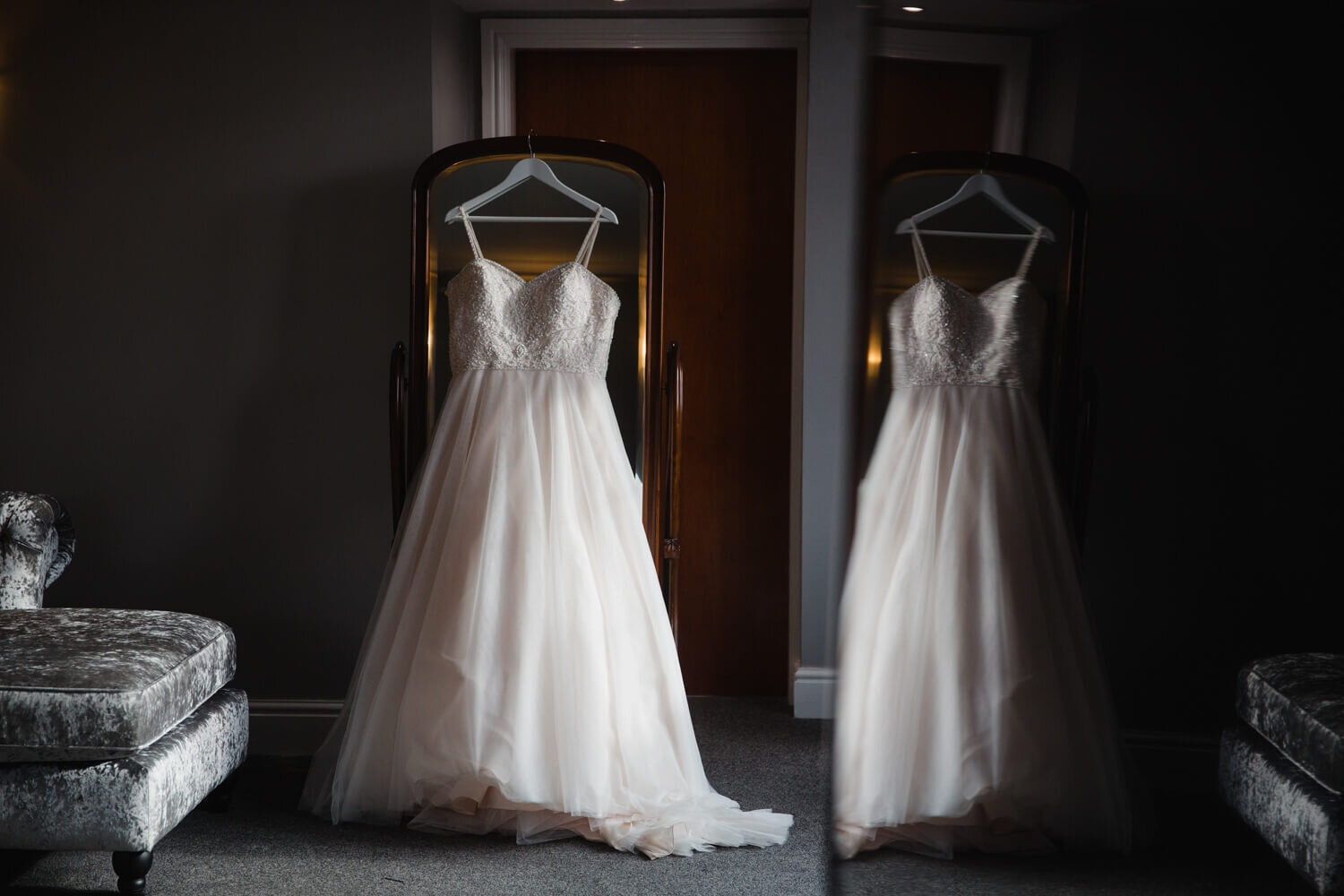 low light exposure photograph of wedding dress in reflection of window