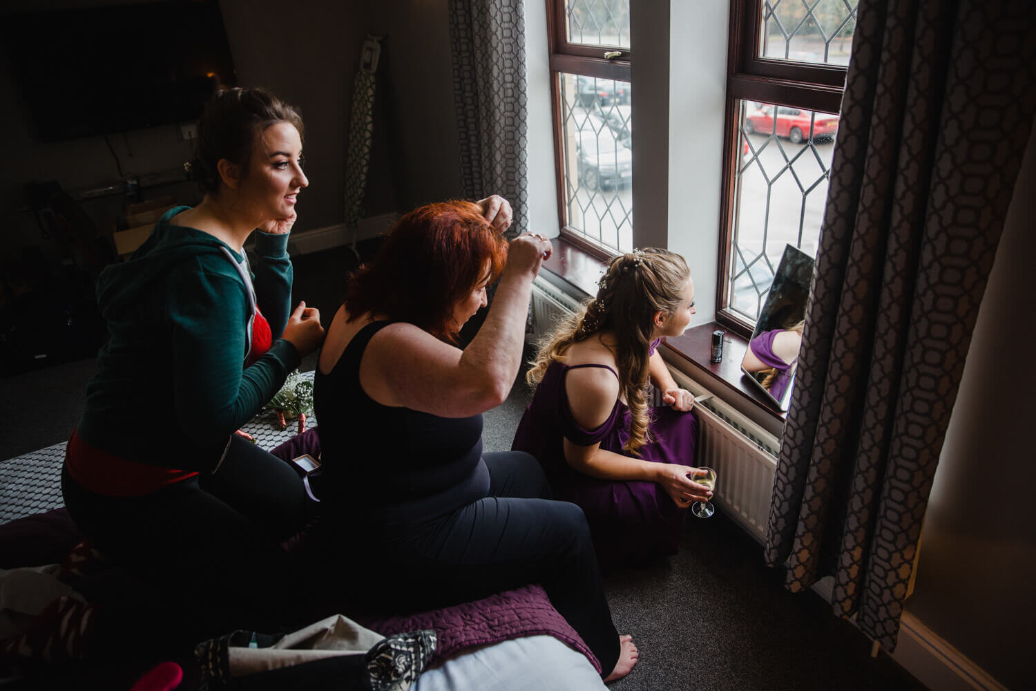 bridesmaids and mother of bride preparation in window at Oakwell Hall