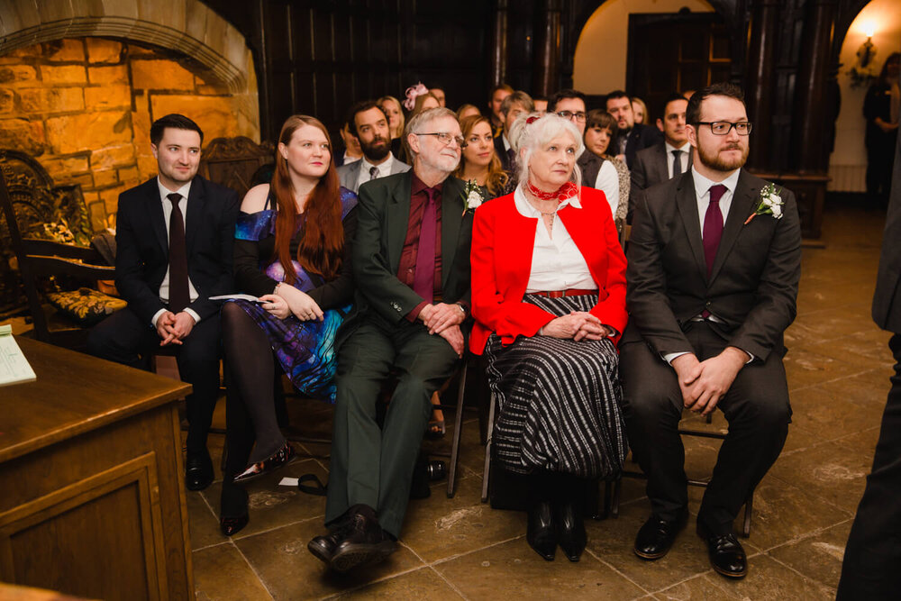 grooms family looks on to wedding service