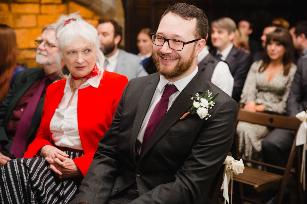 close up macro lens photograph of best man laughing during ceremony