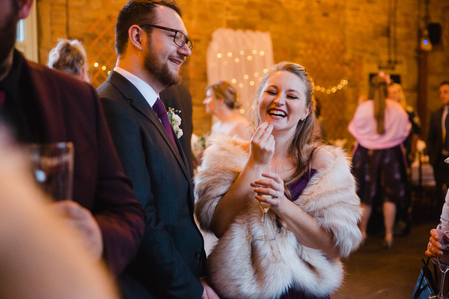 bridesmaid laughs at guests joke after wedding ceremony concludes