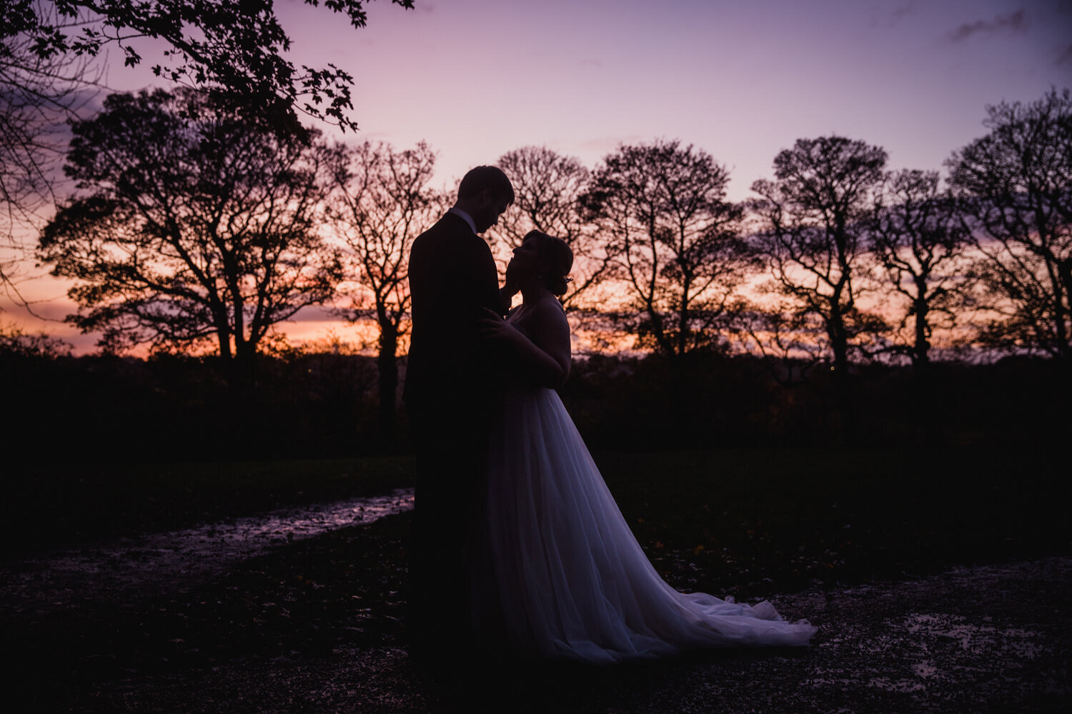 sunset silhouette exposure photograph of newlyweds