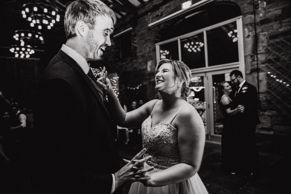monochrome photograph of newly married couple dancing at Oakwell Hall