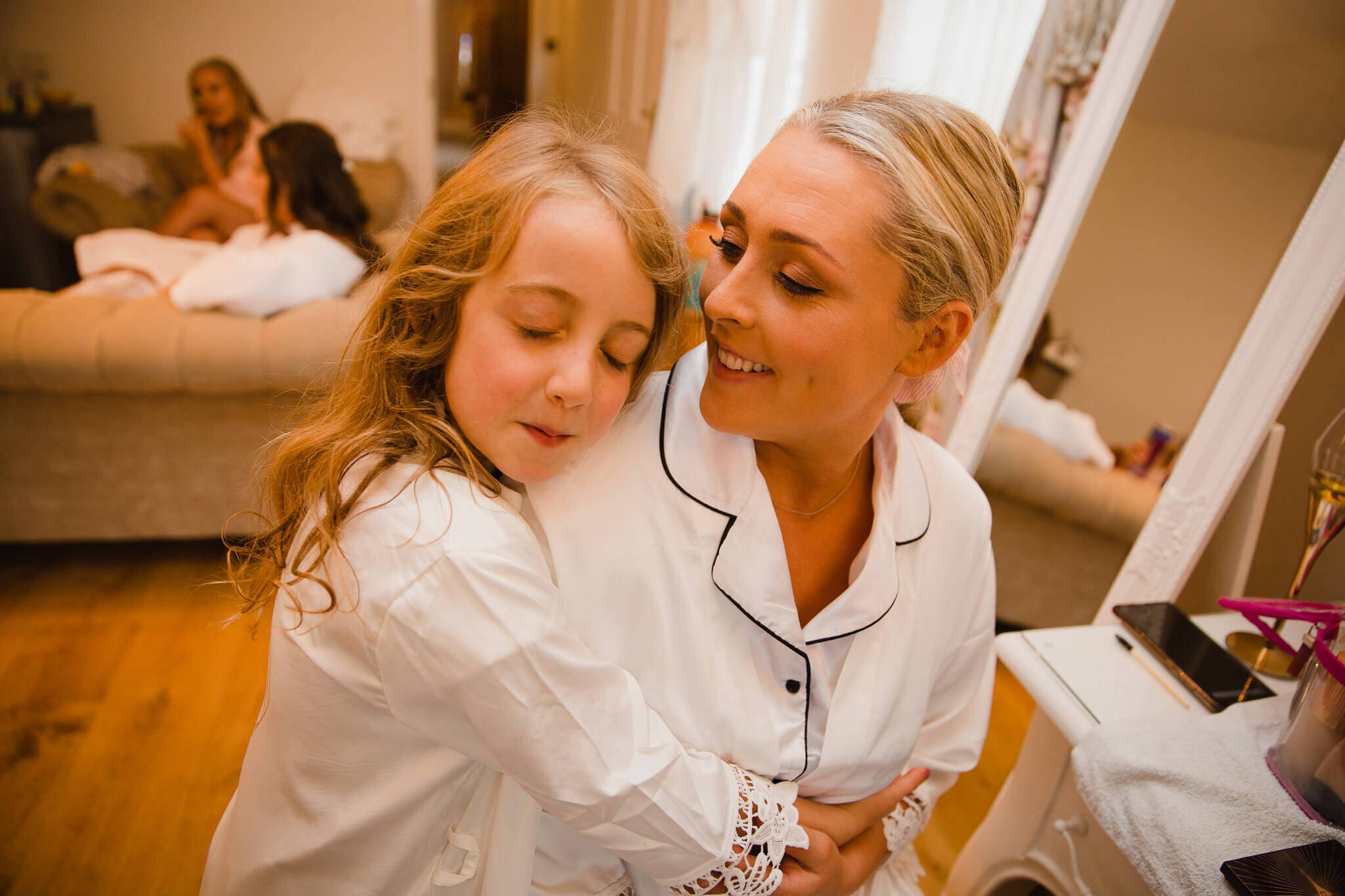 intimate moment as flower girl hugs bride mum