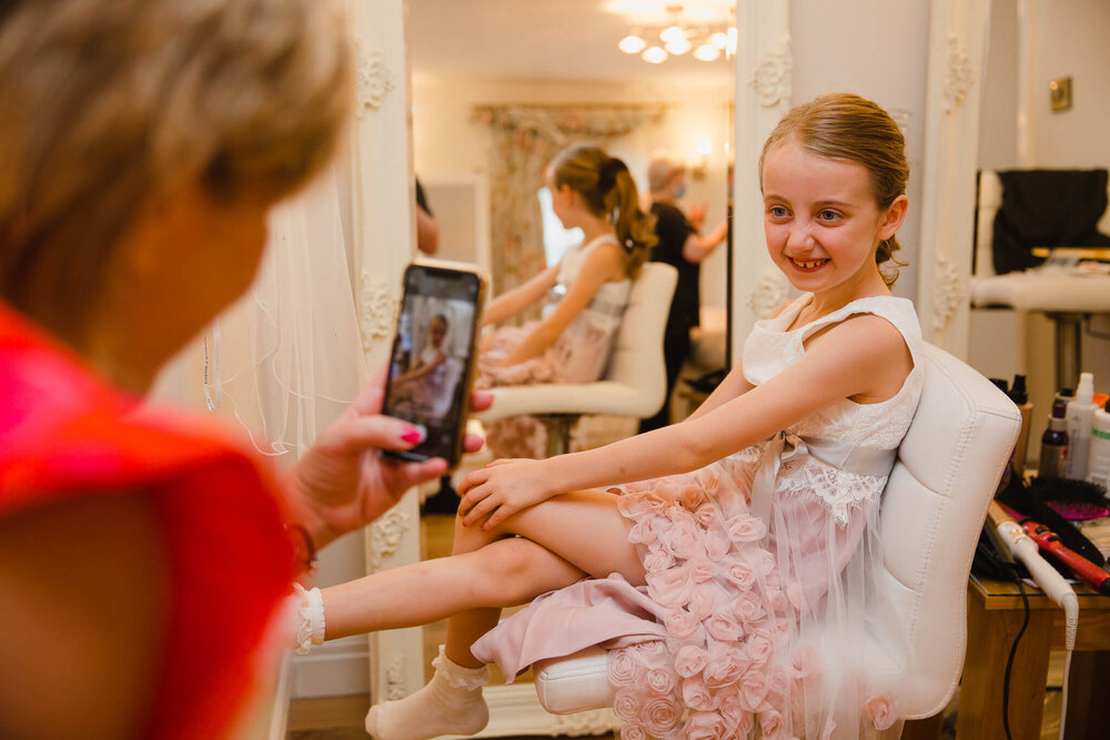 page girl getting ready in bridal suite