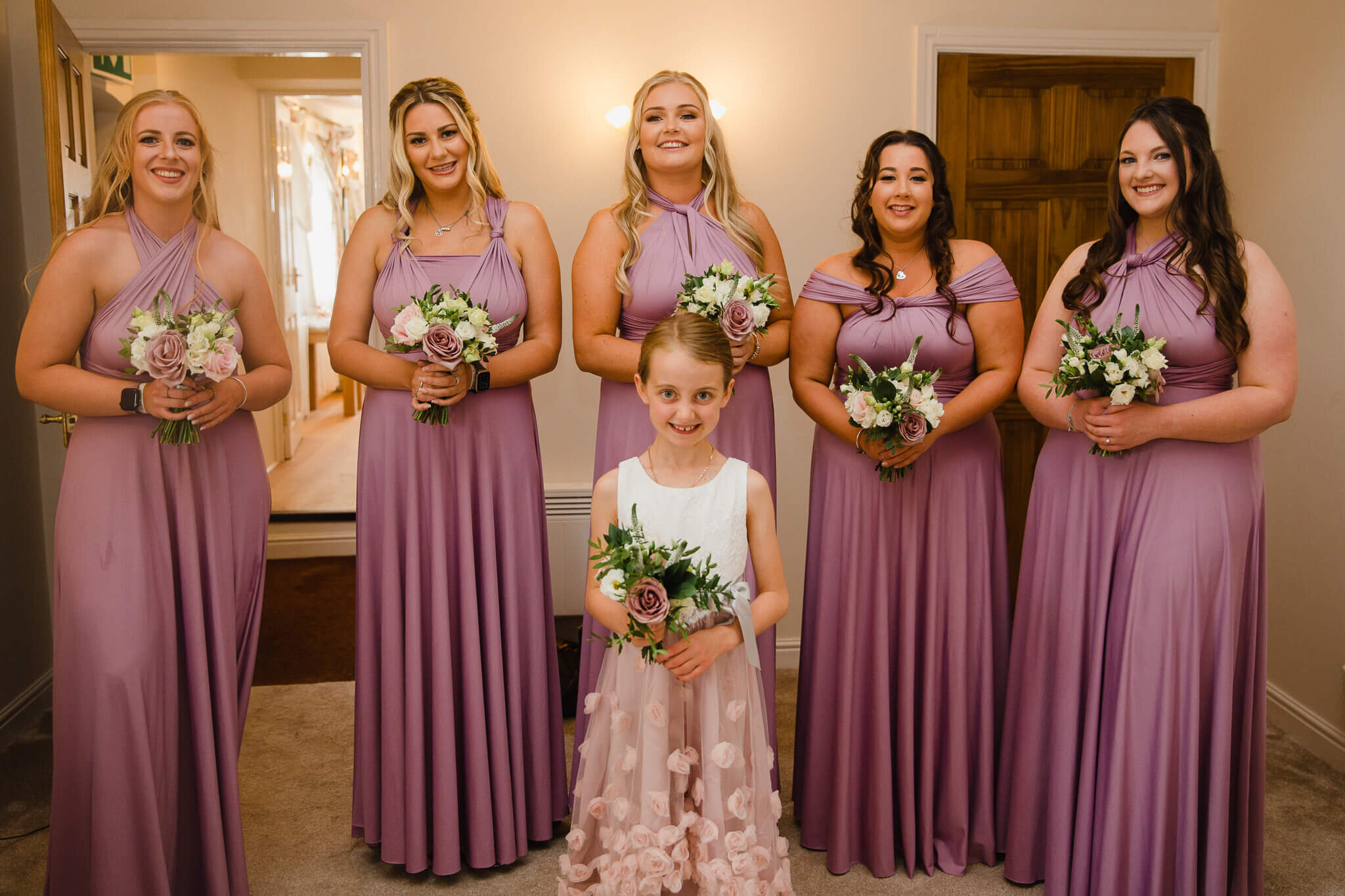 group photograph of bridal party in bridal suite
