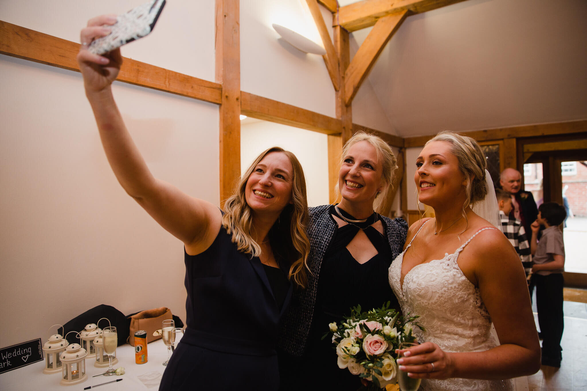 wedding guests share selfie with bride