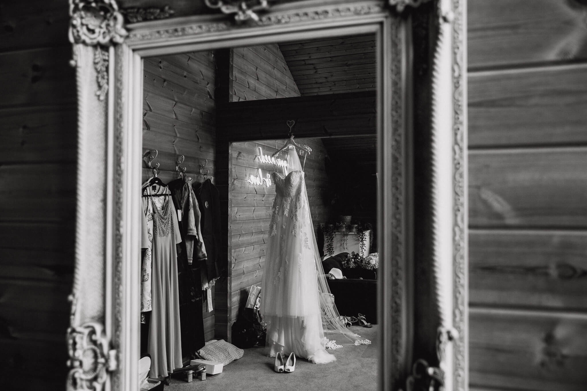 black and white photograph of wedding dress in mirror