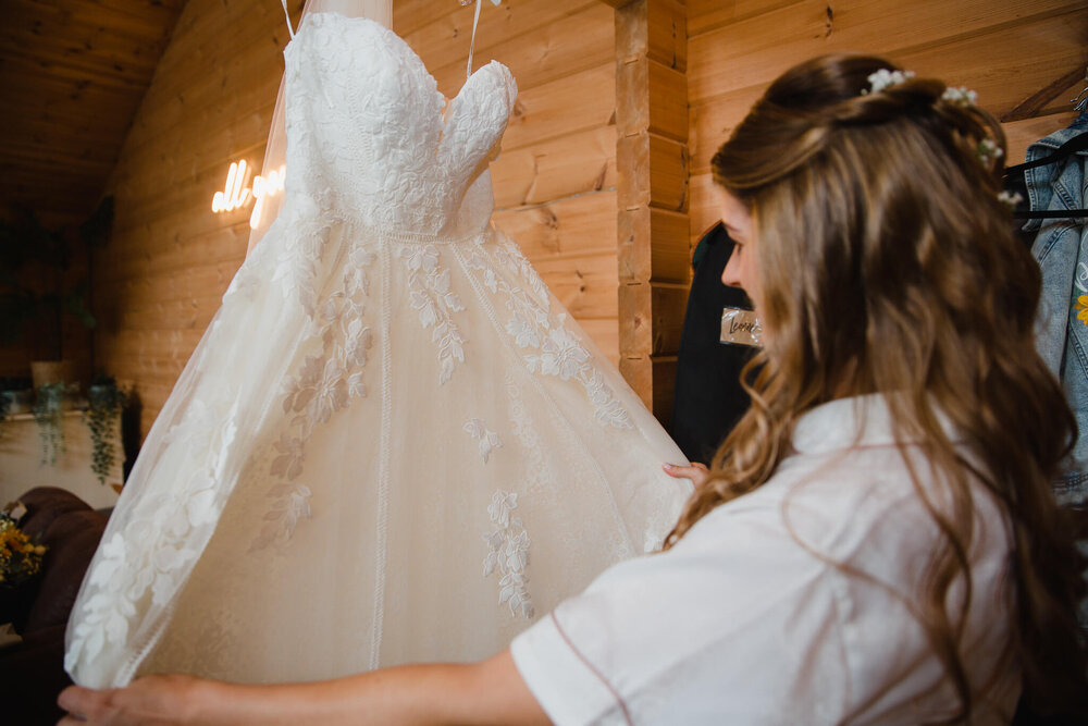 bride fanning out wedding dress during preparation