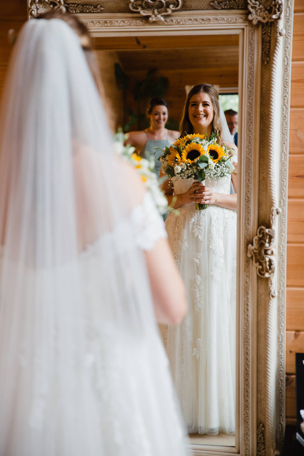 bride occupy bouquet while smiling in mirror