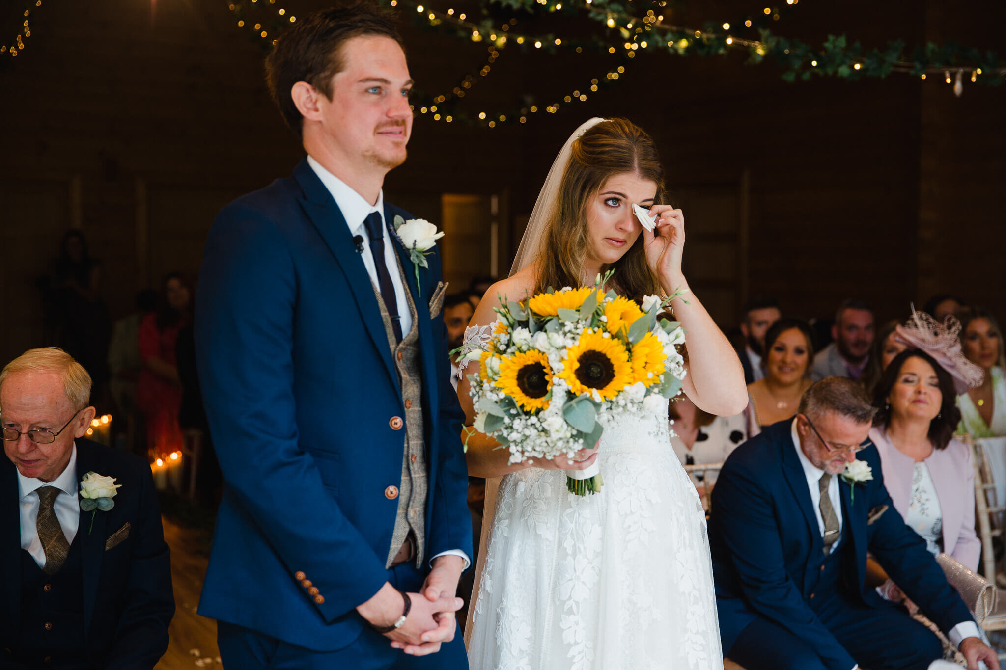 bride crying into tissue