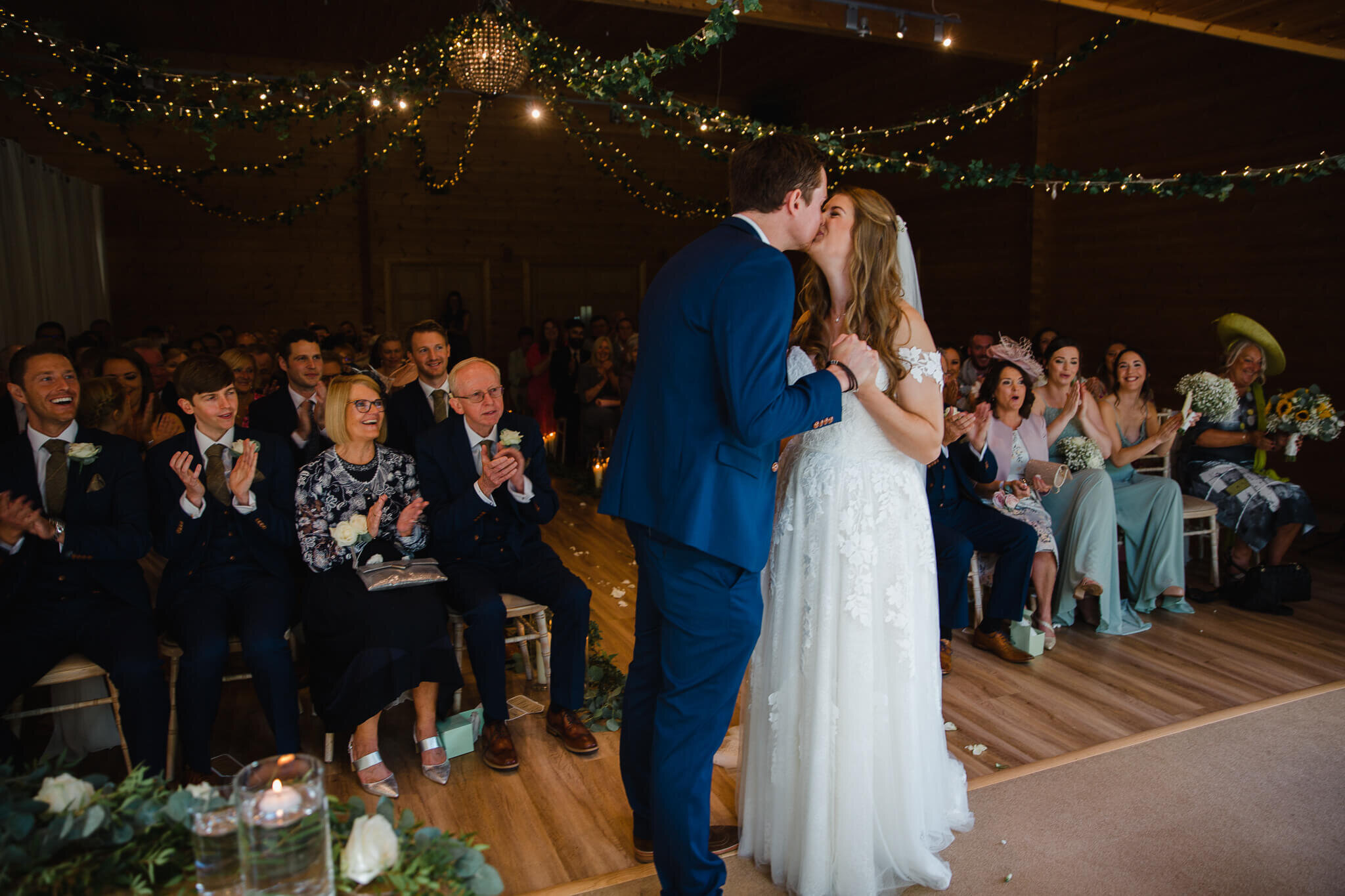 bride and groom share first kiss as everybody applauded