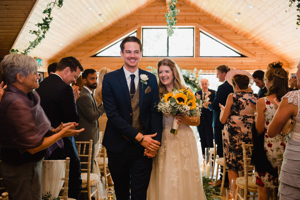 heading up the aisle one last time as newlyweds for their processional