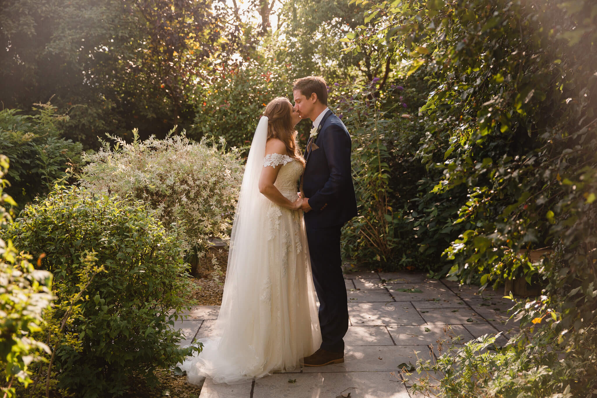 close up kiss by bride and groom