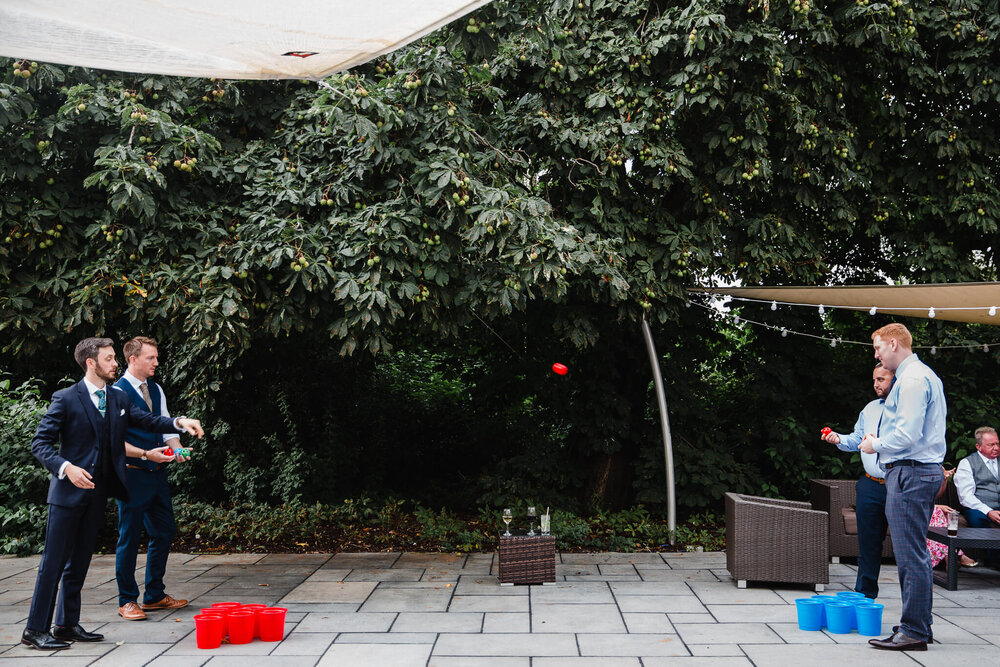 wedding guests in the garden playing beer pong