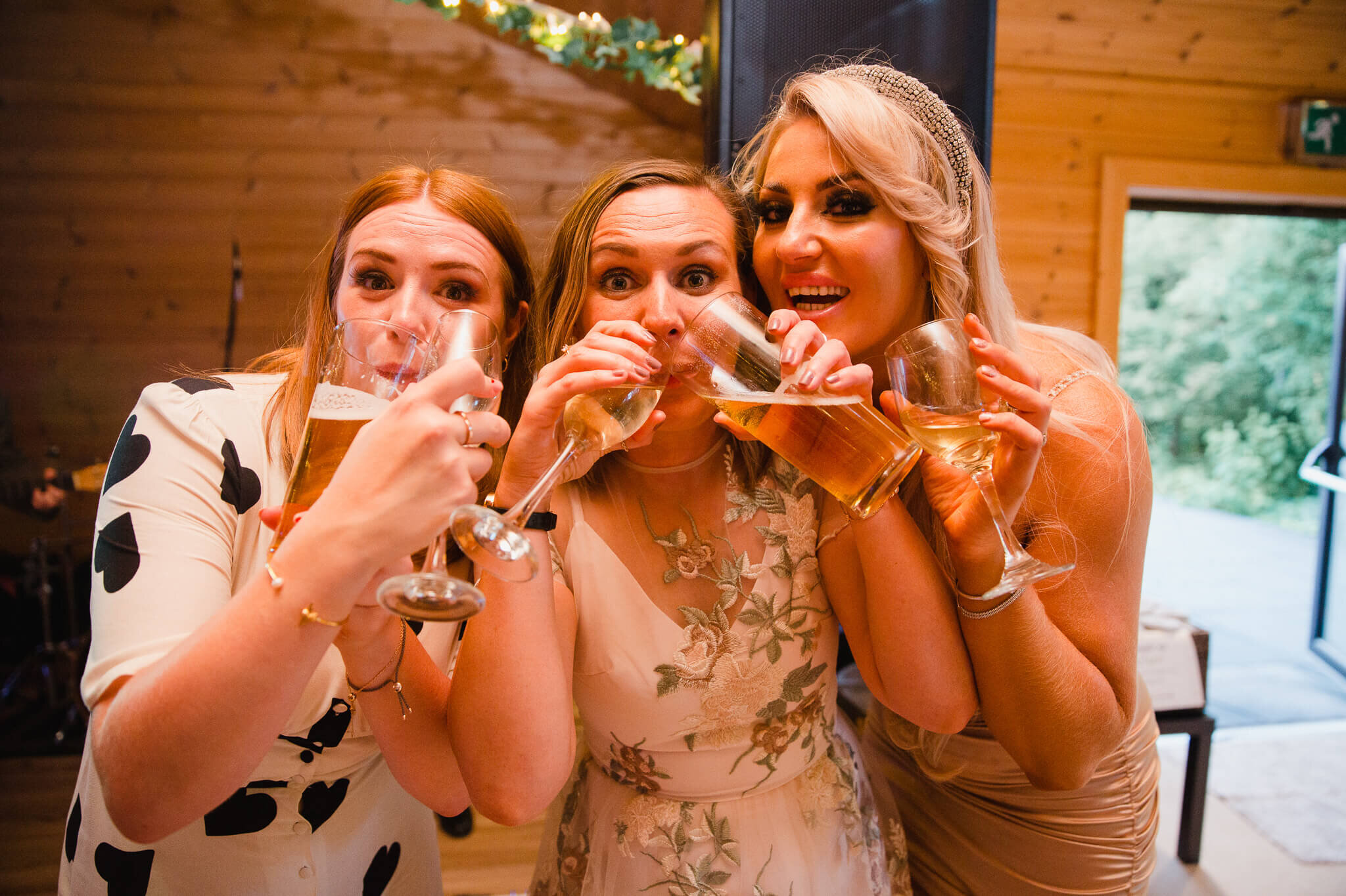 bridesmaids drinking large glasses of wine