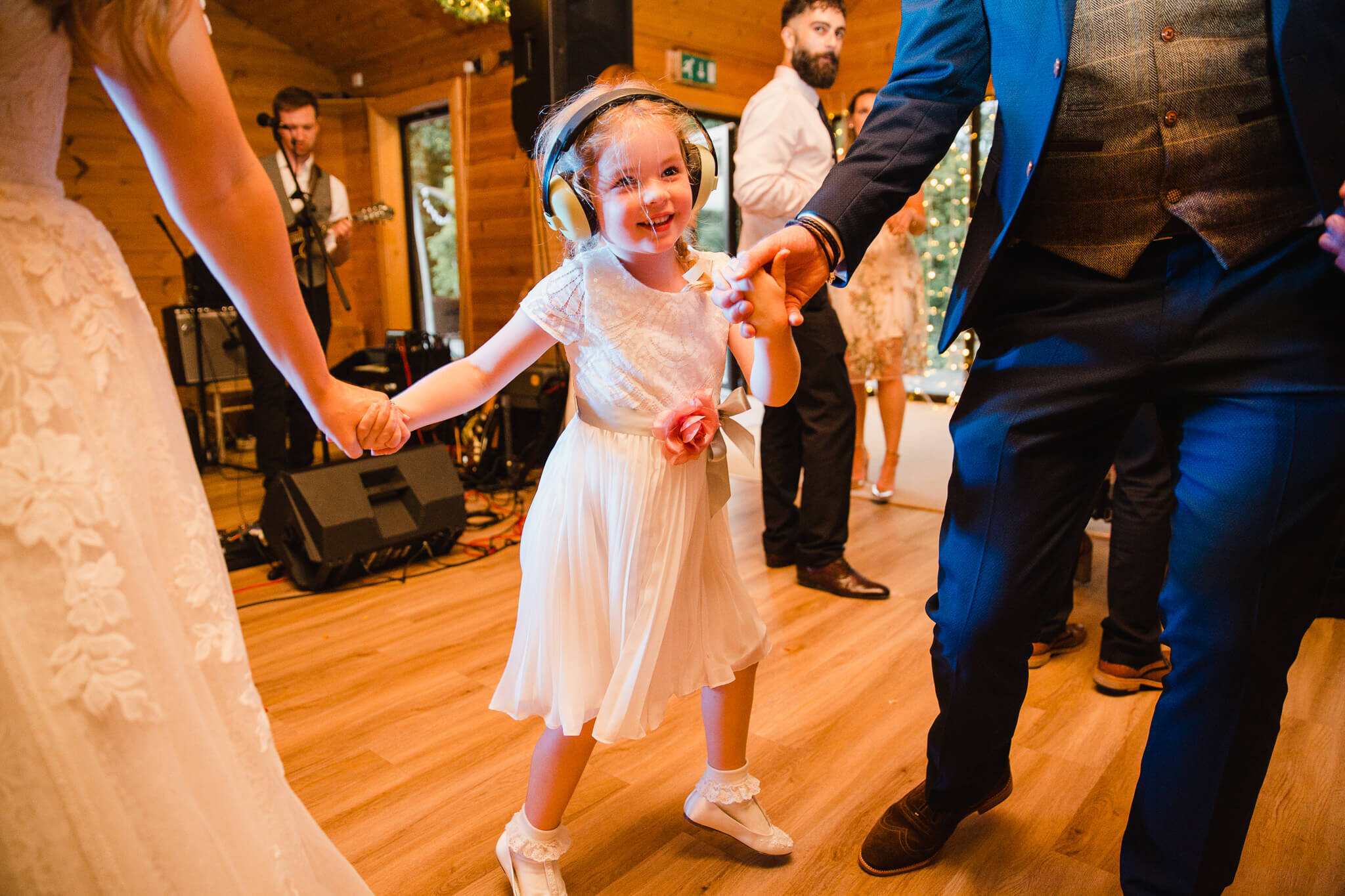 flower girl dancing with wedded couple