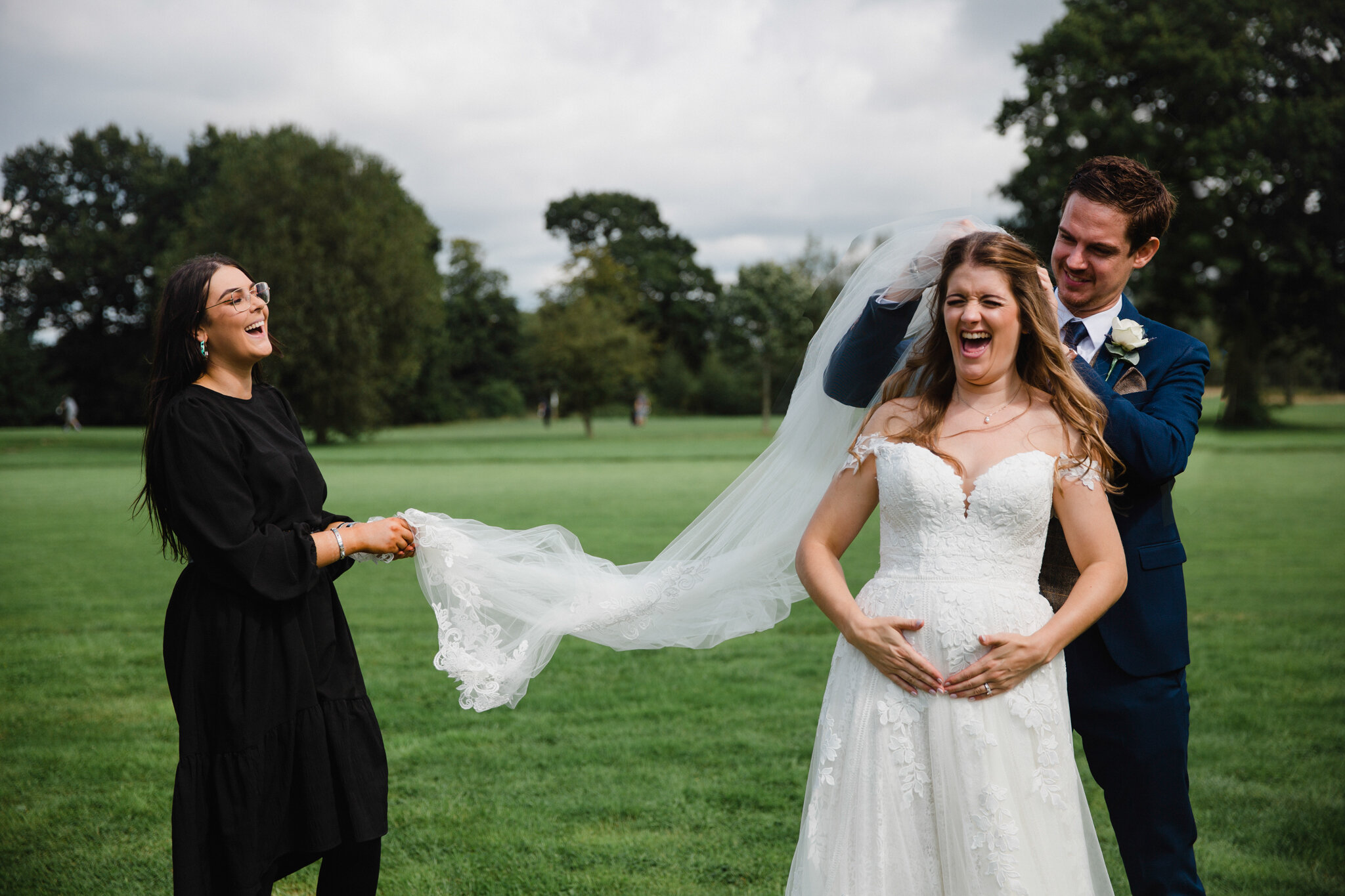 Laura laughing and sharing joke with wedded couple