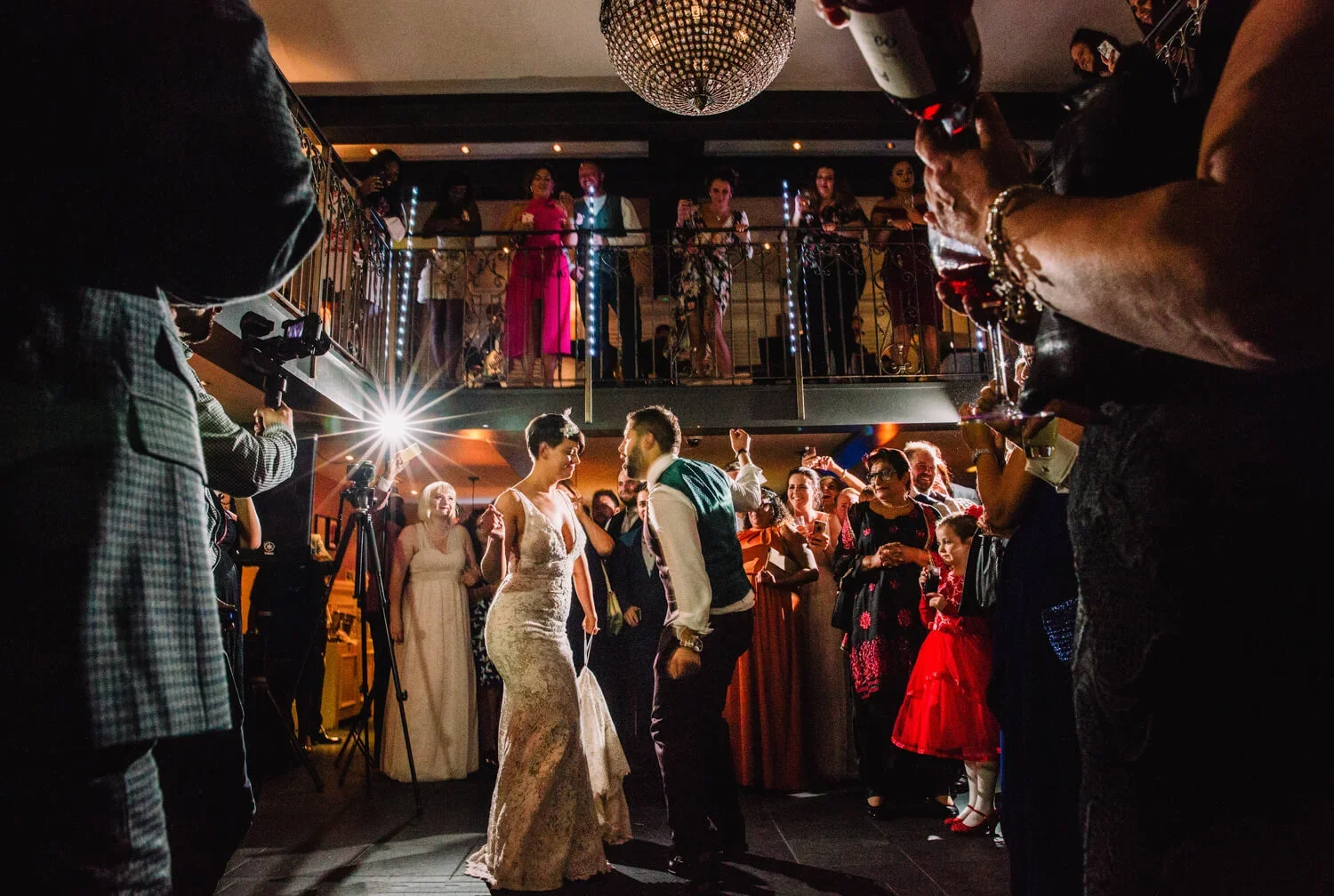 Bride and groom dancing surrounded by guests during a lively King Street Townhouse wedding reception.