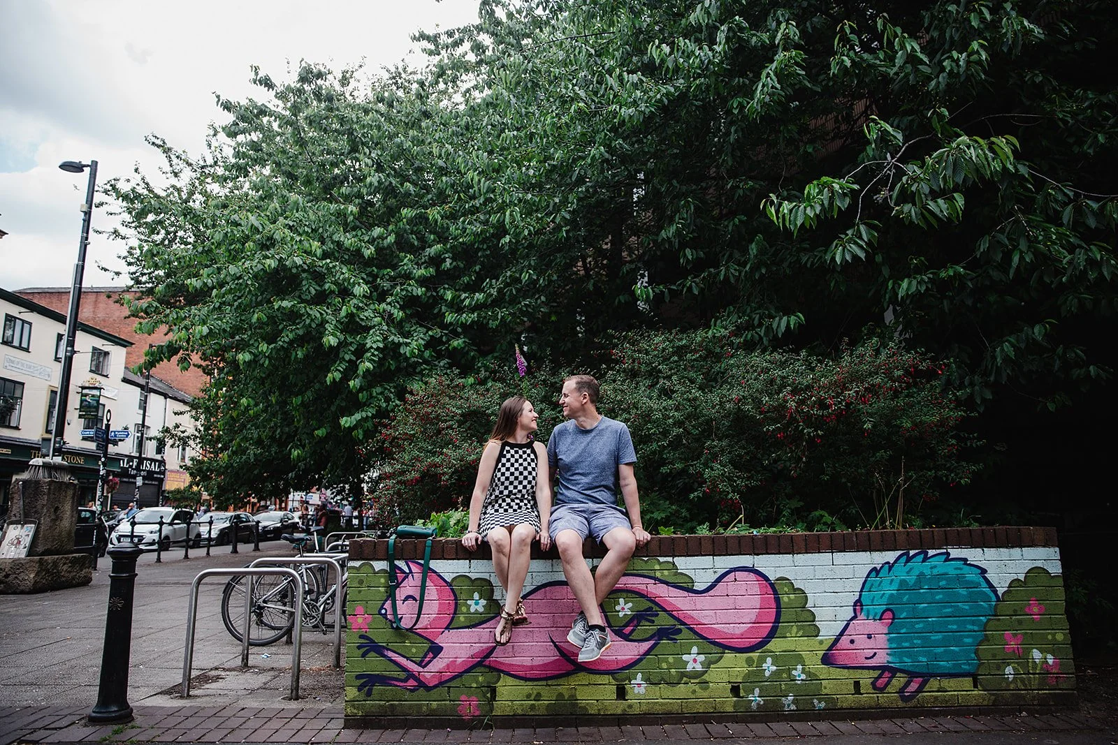 stevenson-square-northern-quarter-couple-sitting-colourful-mural-ledge.jpg
