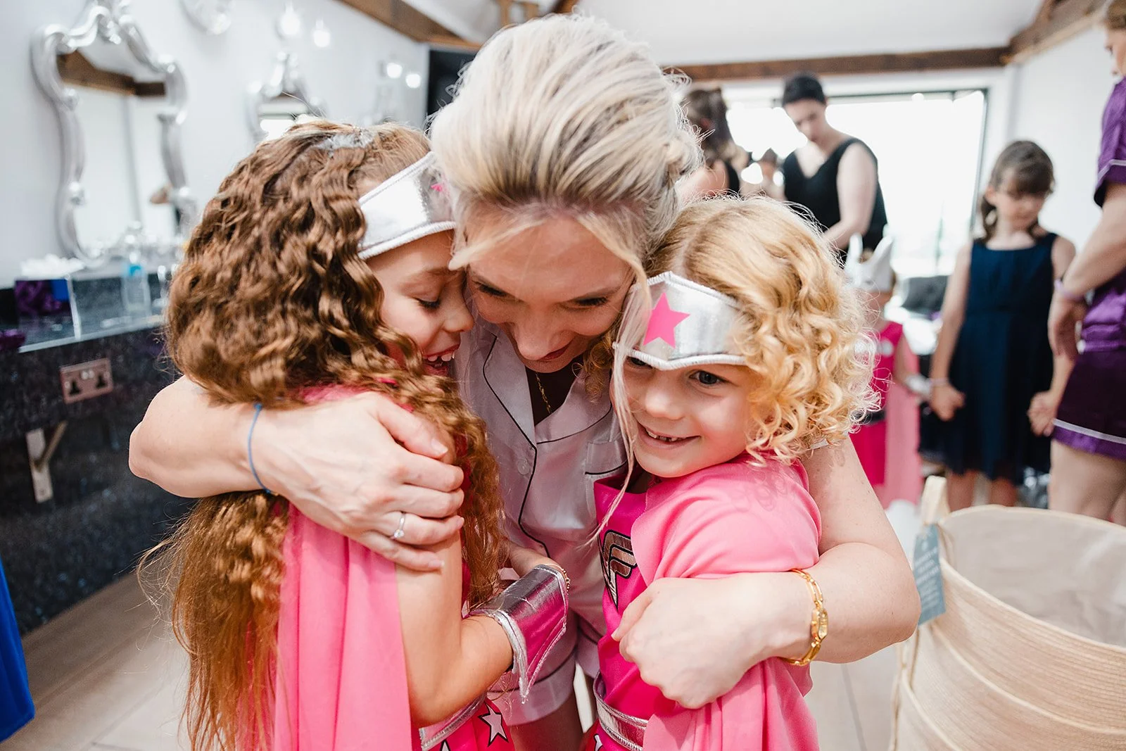 heaton-house-farm-wedding-bride-hugging-wonder-woman-flower-girls.jpg
