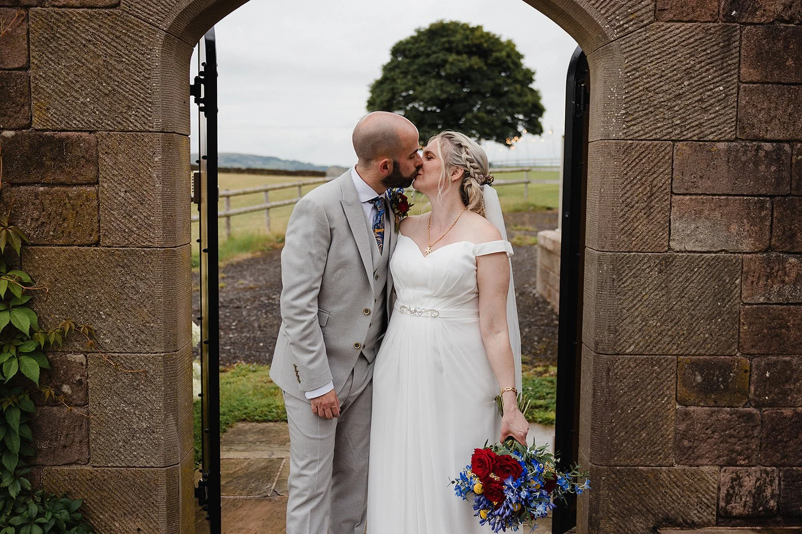 heaton-house-farm-wedding-couple-kiss-sycamore-tree.jpg