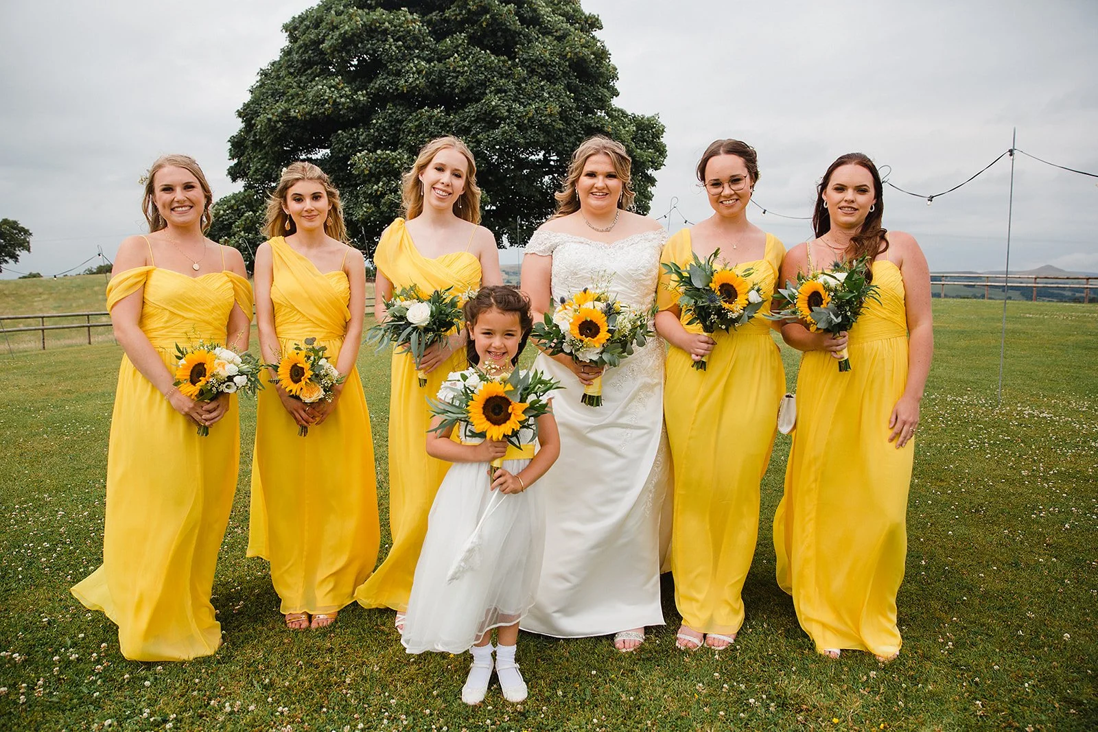 heaton-house-farm-wedding-bridesmaids-sunflower-bouquets.jpg