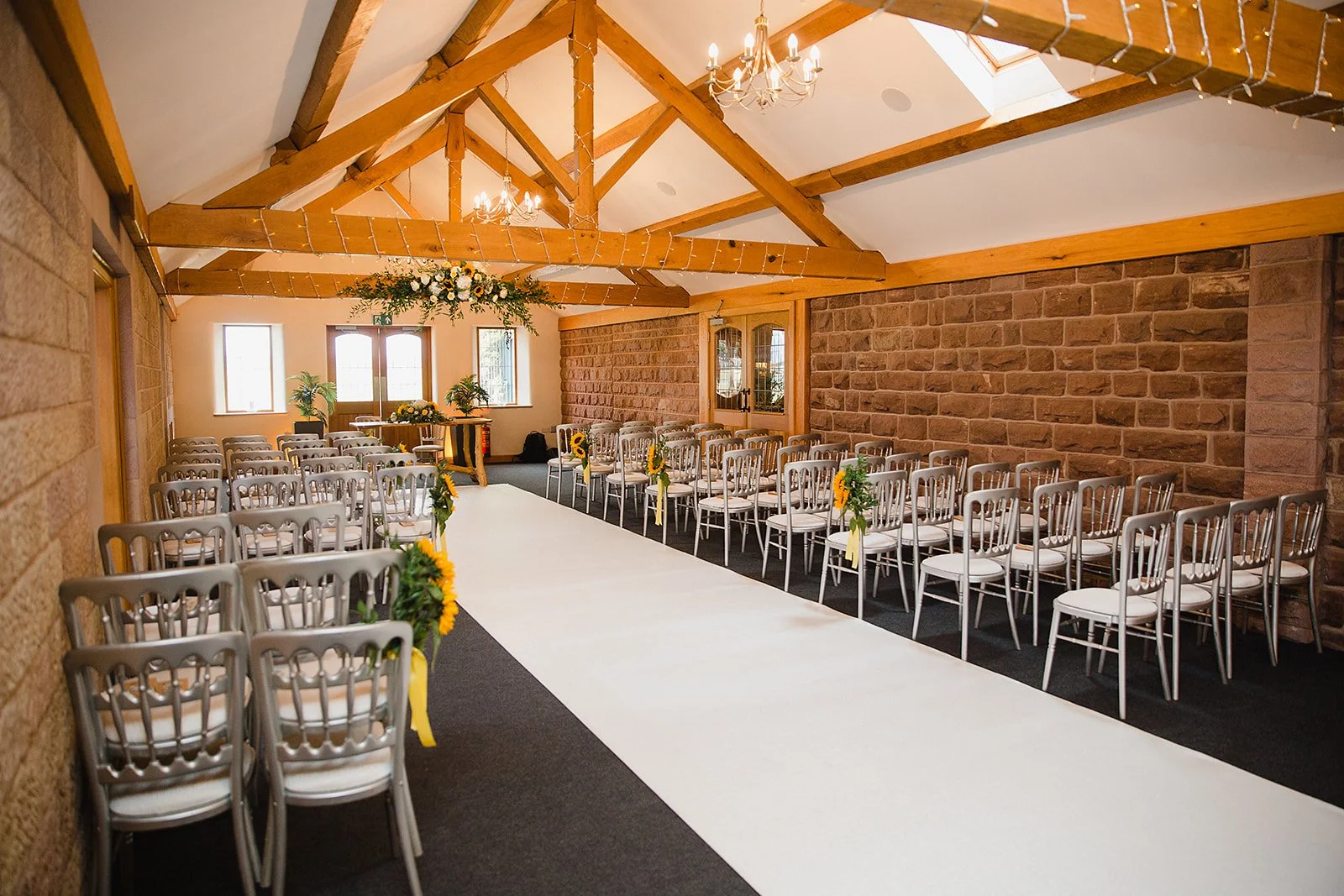 heaton-house-farm-indoor-ceremony-stableyard-aisle.jpg