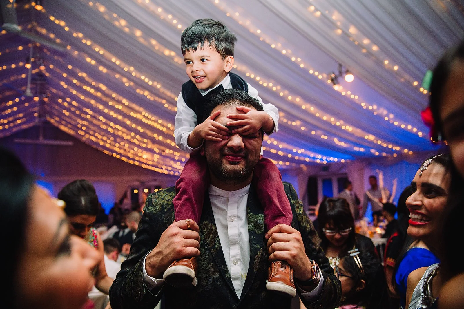 heaton-house-farm-indian-wedding-child-on-shoulders-dancefloor.jpg  