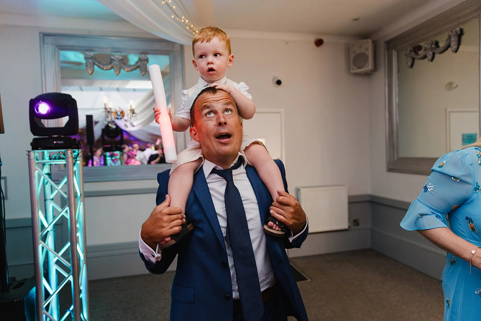 stirk-house-wedding-child-on-shoulders-light-baton.jpg