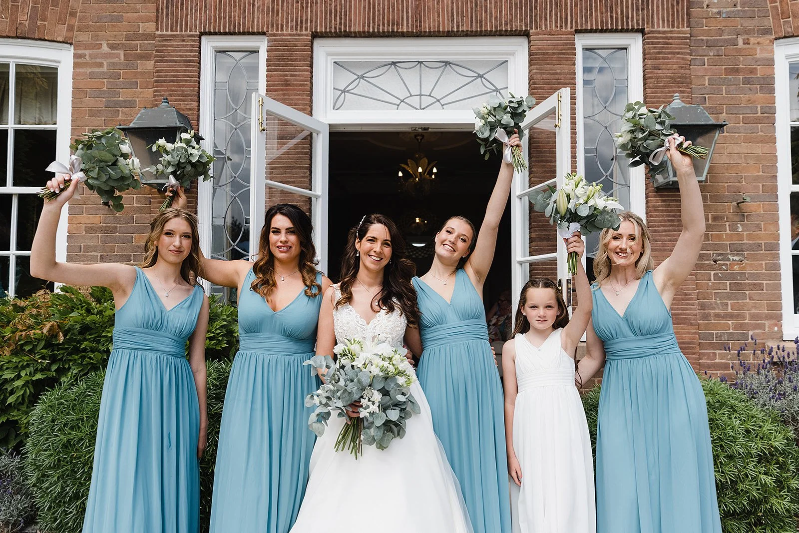 delamere-manor-wedding-bridesmaids-entrance-bouquets-in-air.jpg