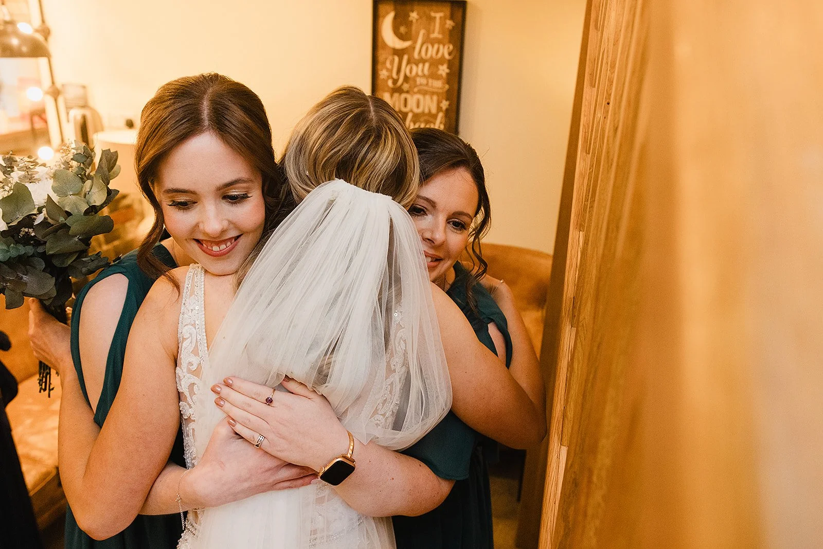 ashes-barns-wedding-bride-hugging-bridesmaids.jpg