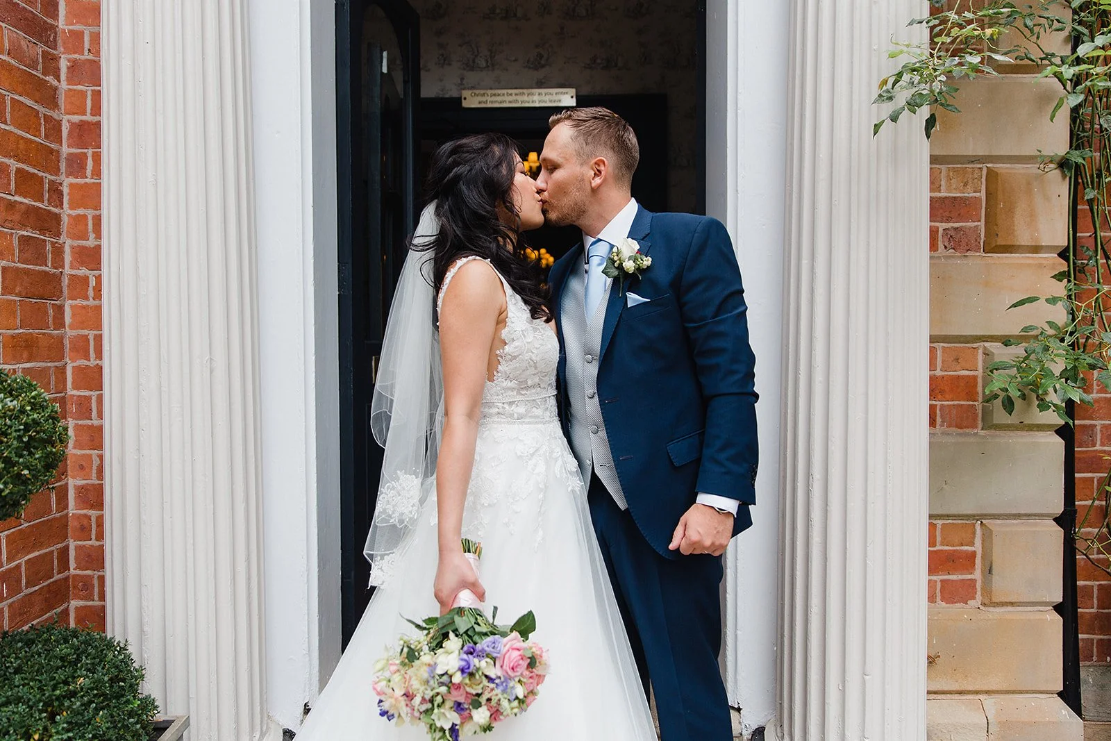 ashfield-house-wedding-couple-kissing-front-entrance.jpg