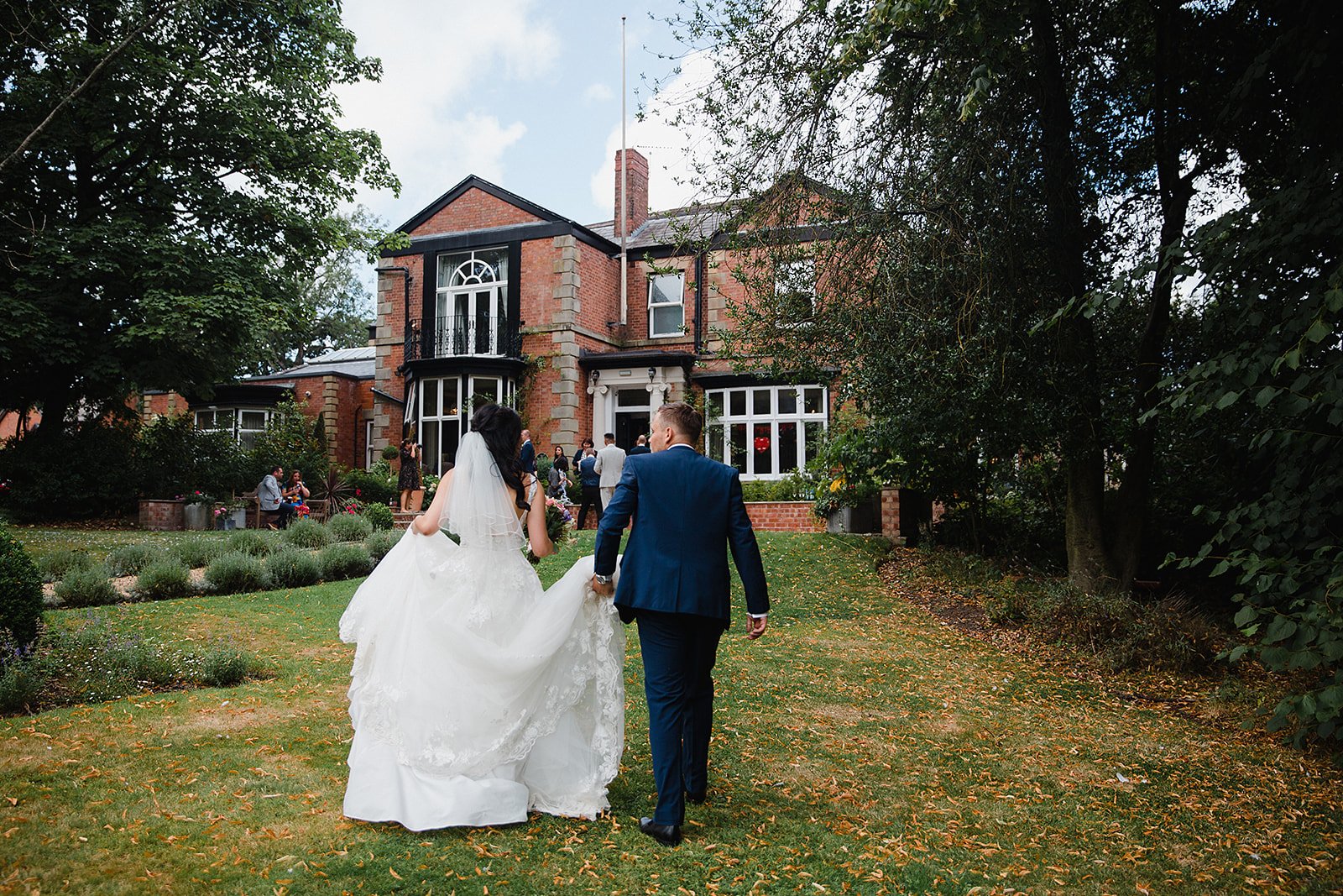 ashfield-house-wedding-couple-walking-gardens.jpg