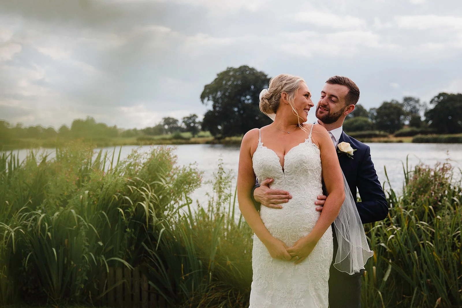 sandhole-oak-barn-wedding-photography-lakeside-long-grass-embrace.jpg