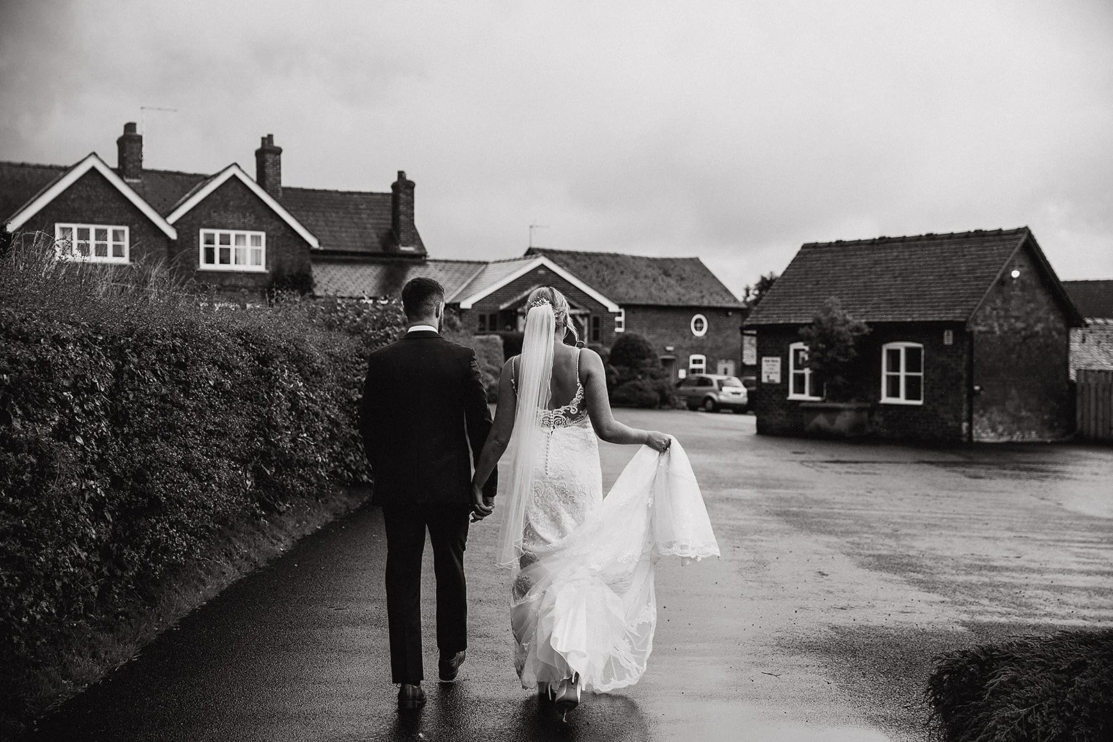 sandhole-oak-barn-wedding-photography-couple-walking-wet-path.jpg