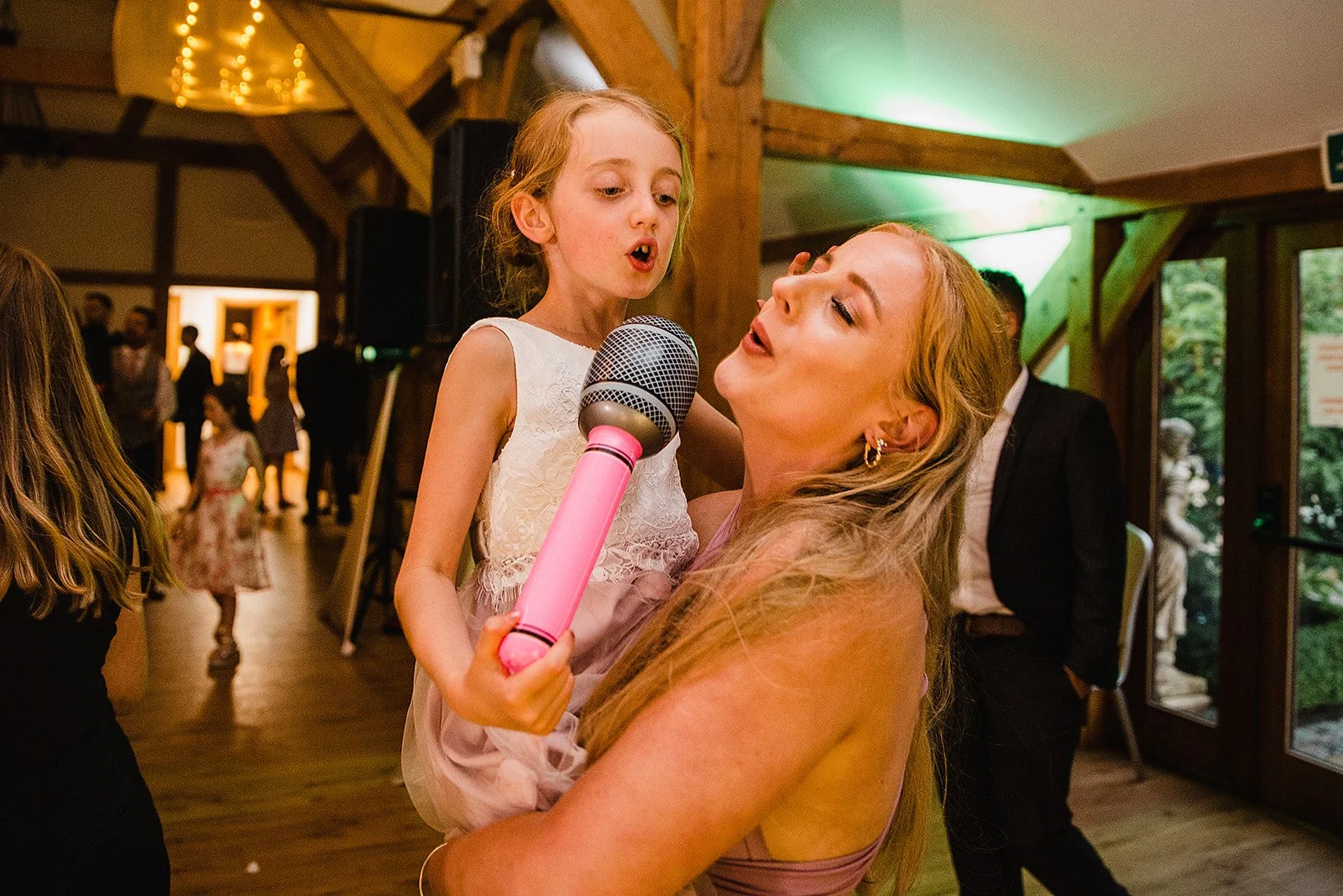 sandhole-oak-barn-wedding-flowergirl-bridesmaid-inflatable-microphone.jpg