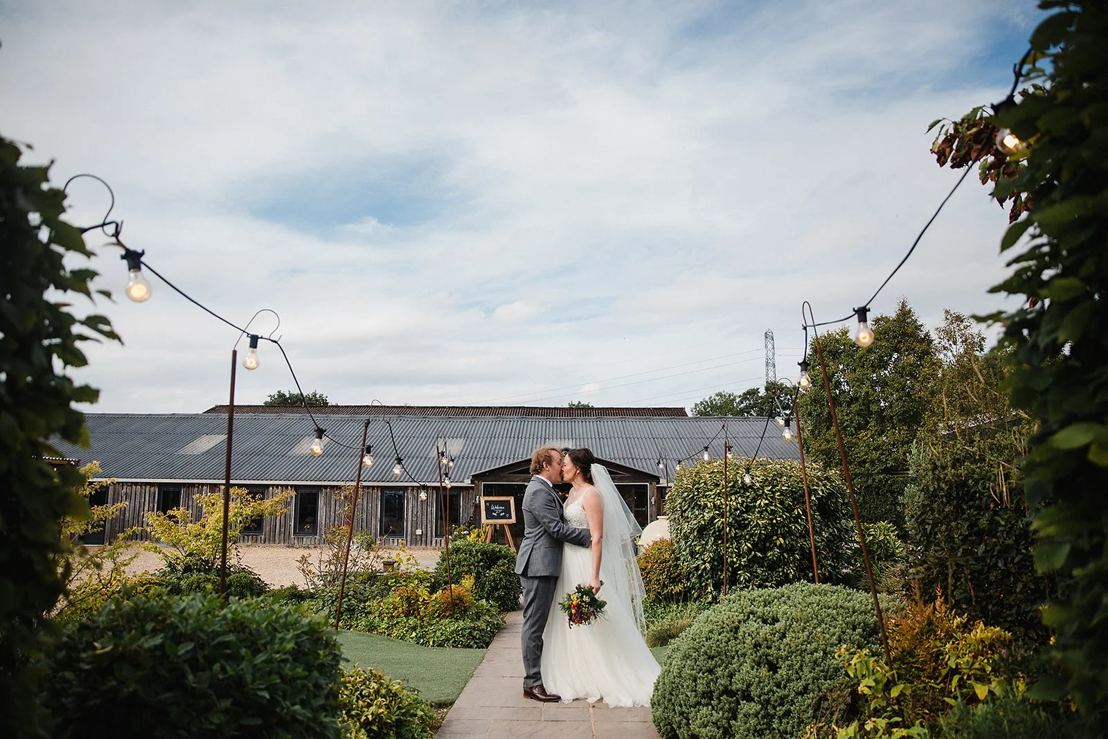 owen-house-wedding-barn-wedding-photography-outside-venue-kiss.jpg