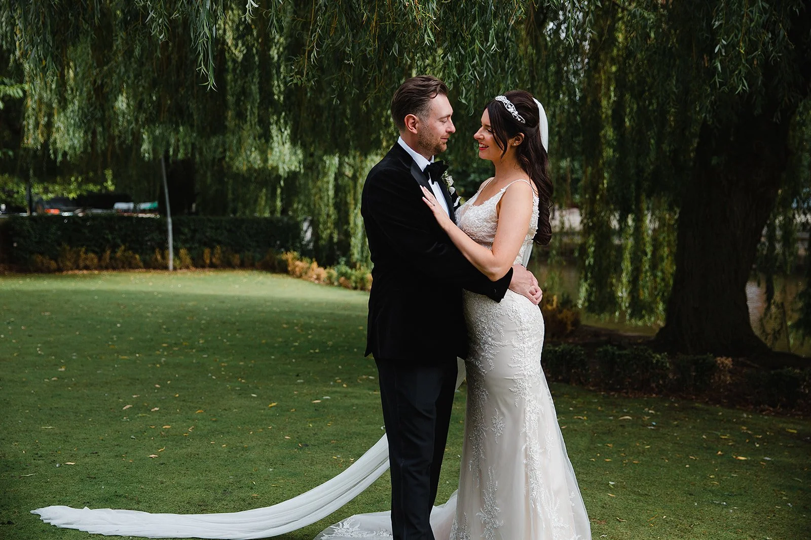 Bride and groom portrait beneath willow trees during The Castlefield Rooms wedding in Manchester